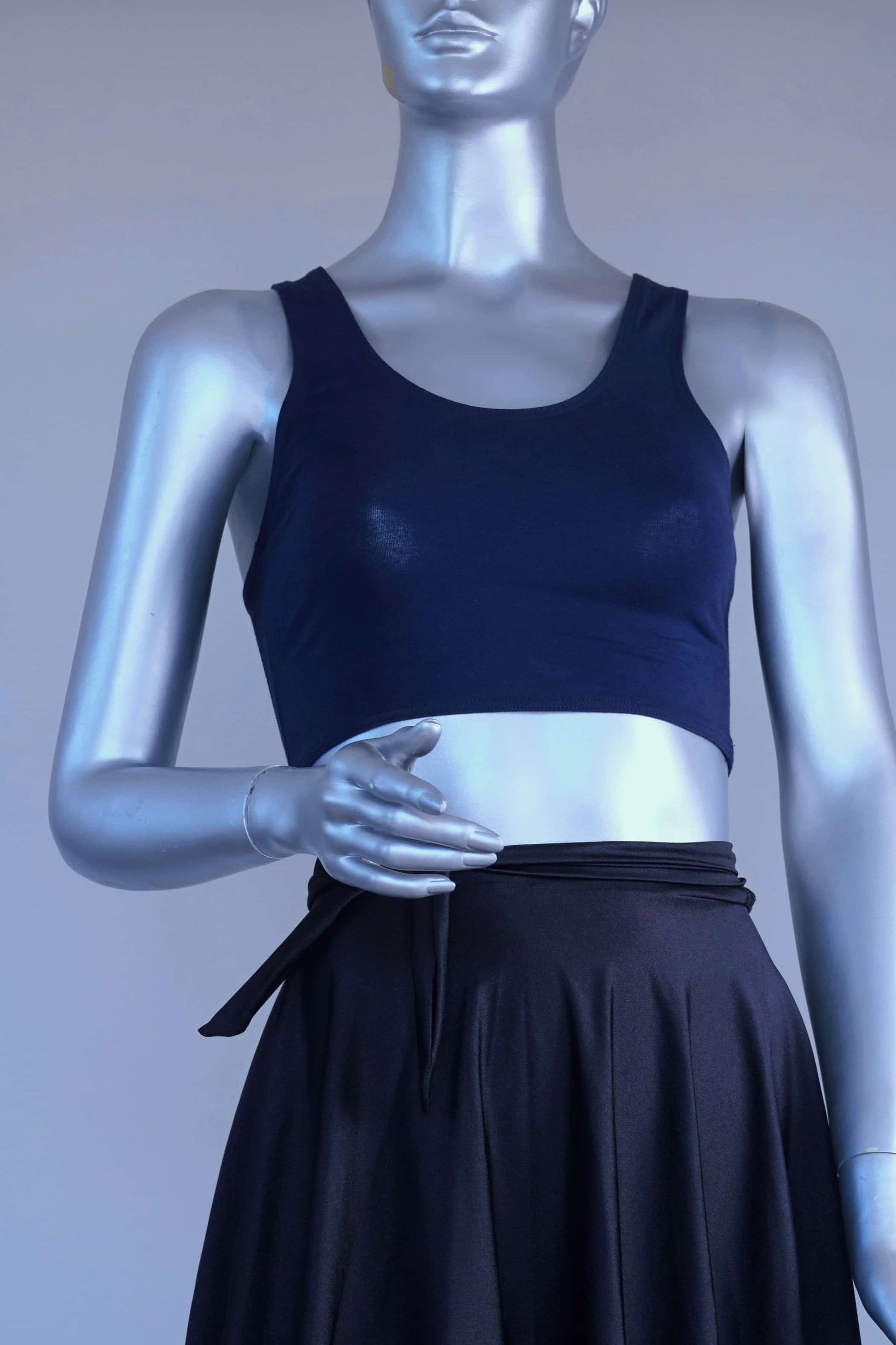 Mannequin wearing a navy crop top against a plain background