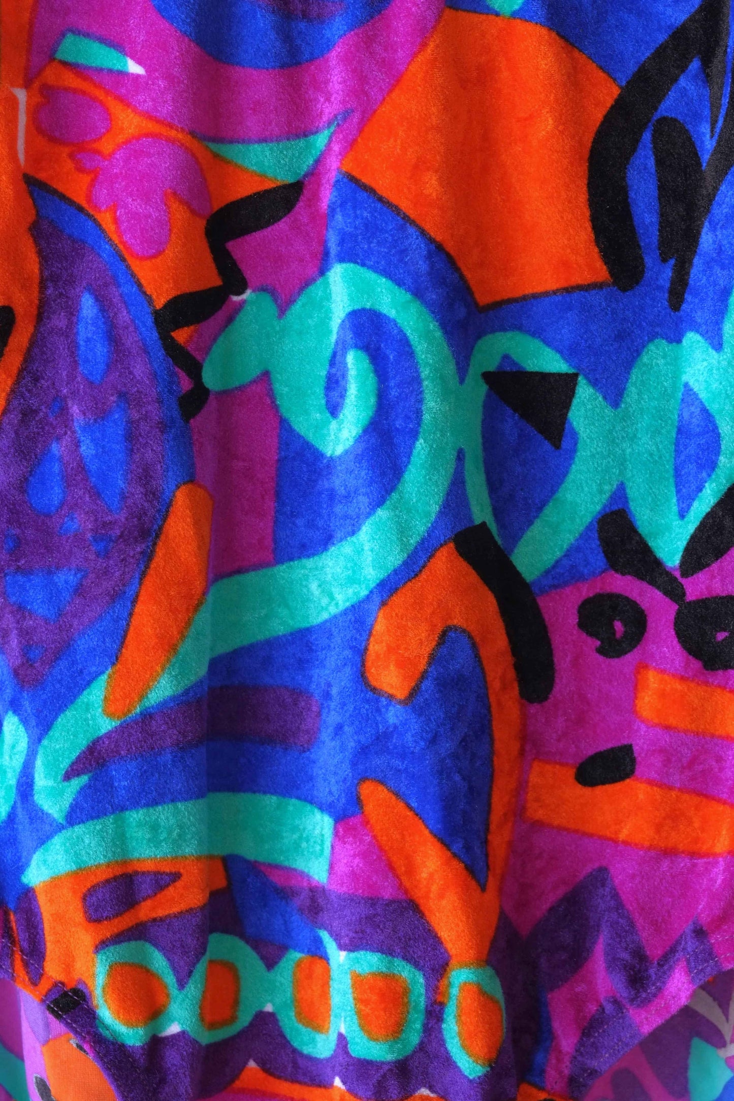 Close up of the fabric of a colorful vintage Anniel one-piece leotard.