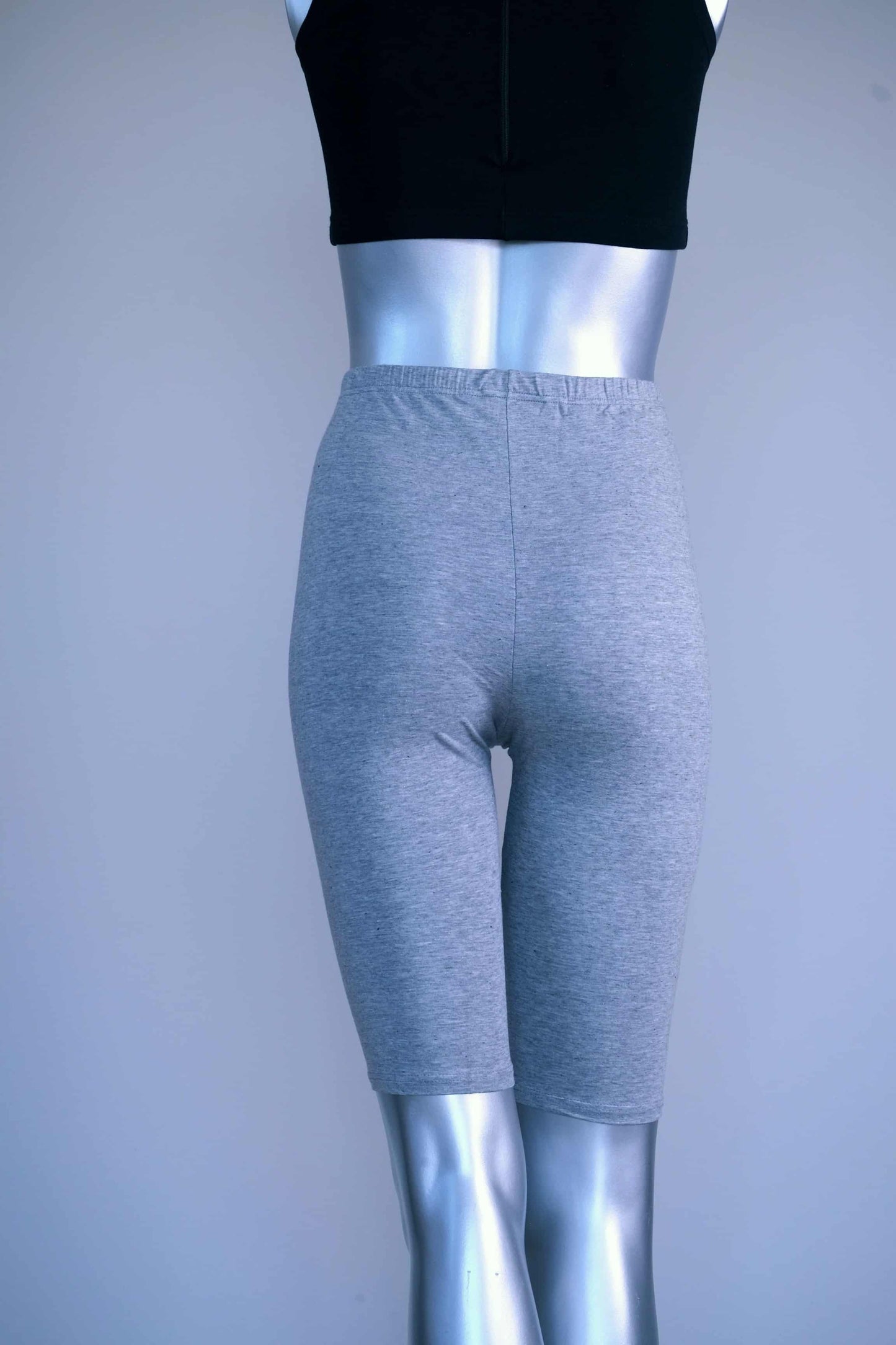 BAck view of vintage above the knee grey biker shorts on a silver mannequin.