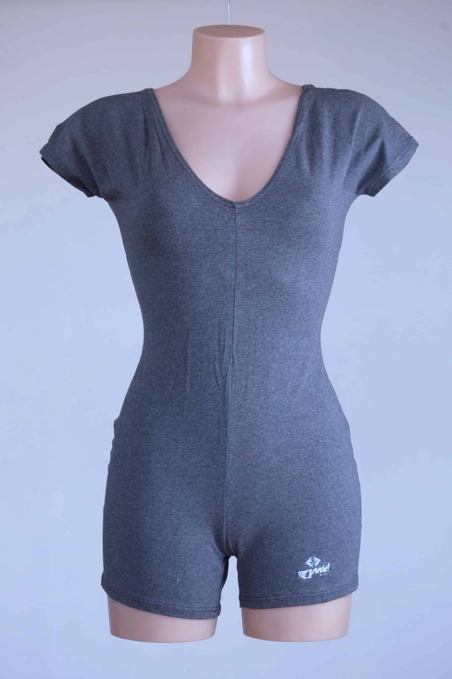 Anniel athletic romper in heather charcoal displayed on mannequin with V-neck and fitted silhouette.