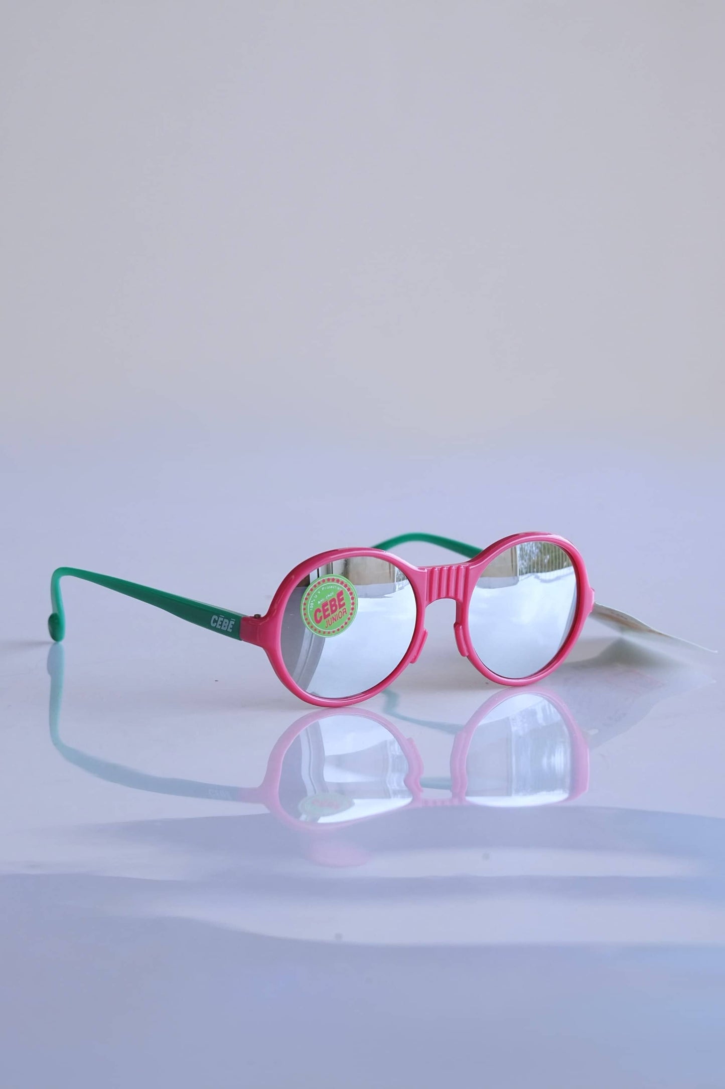 CÉBÉ Baby Glasses in pink and green and mirror lenses