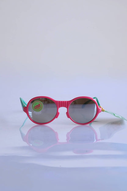 CÉBÉ Baby Glasses in pink and green on white background