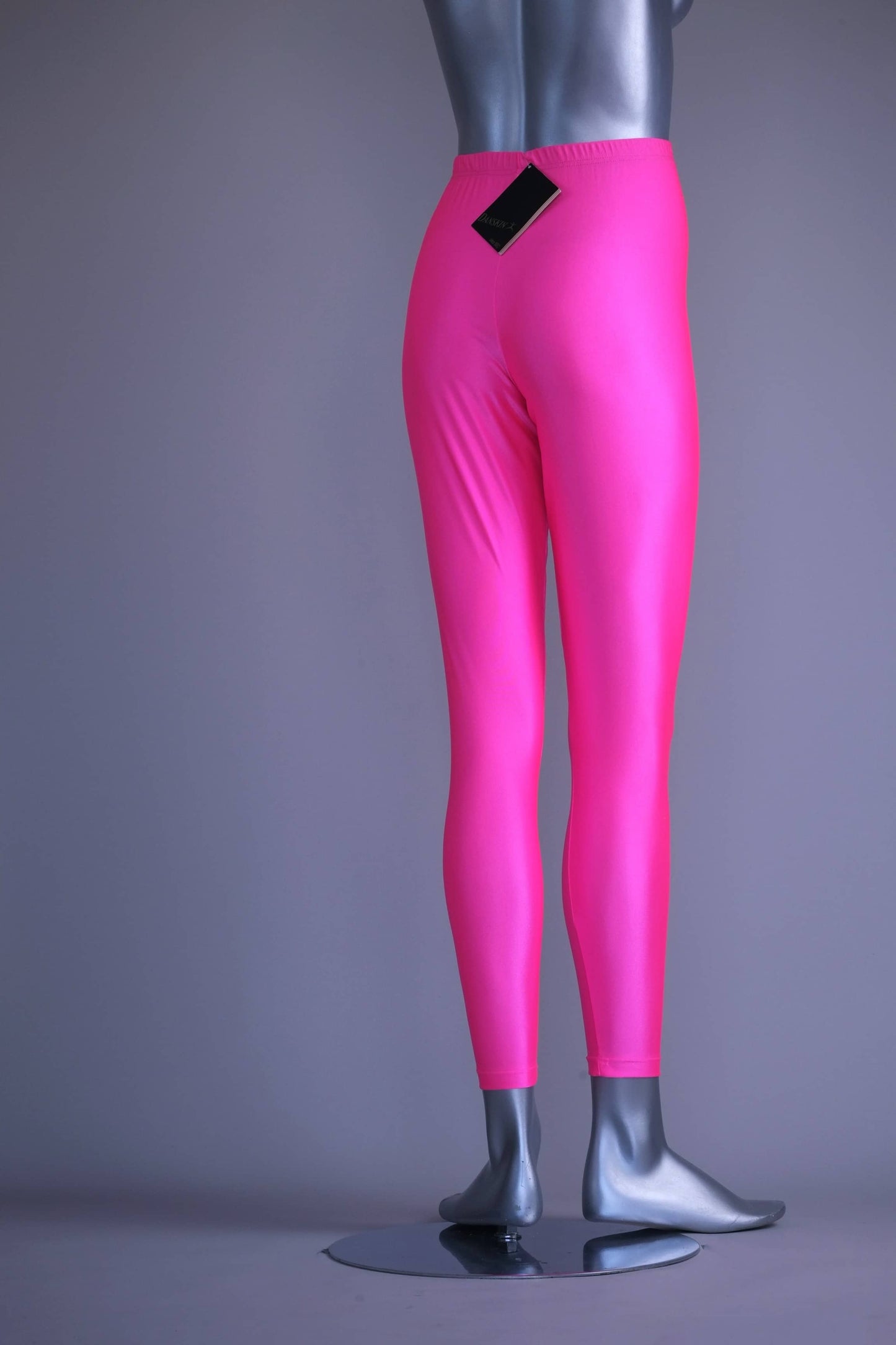 Back view of A mannequin wearing a pair of shiny neon pink vintage 90s Danskin high-waist leggings.
