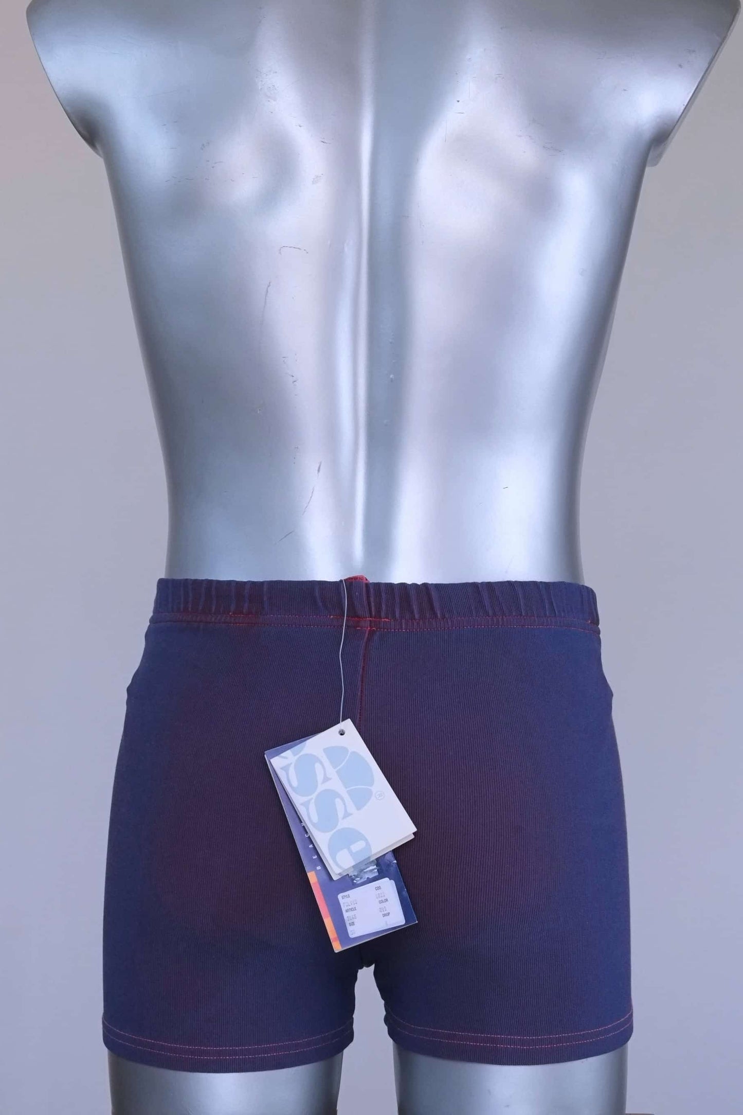 Back view of vintage Ellesse swim trunks showing original paper tags attached at waistband.