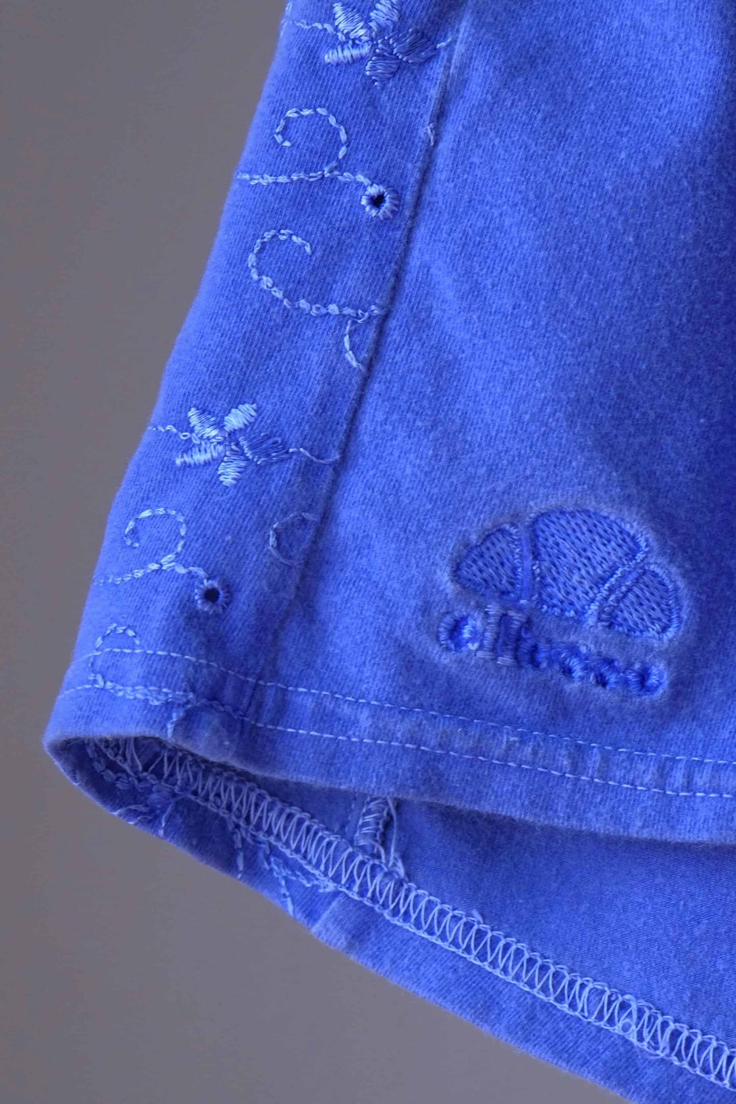 Detail of floral embroidery and Ellesse logo on vintage 90s terry cloth hot pants