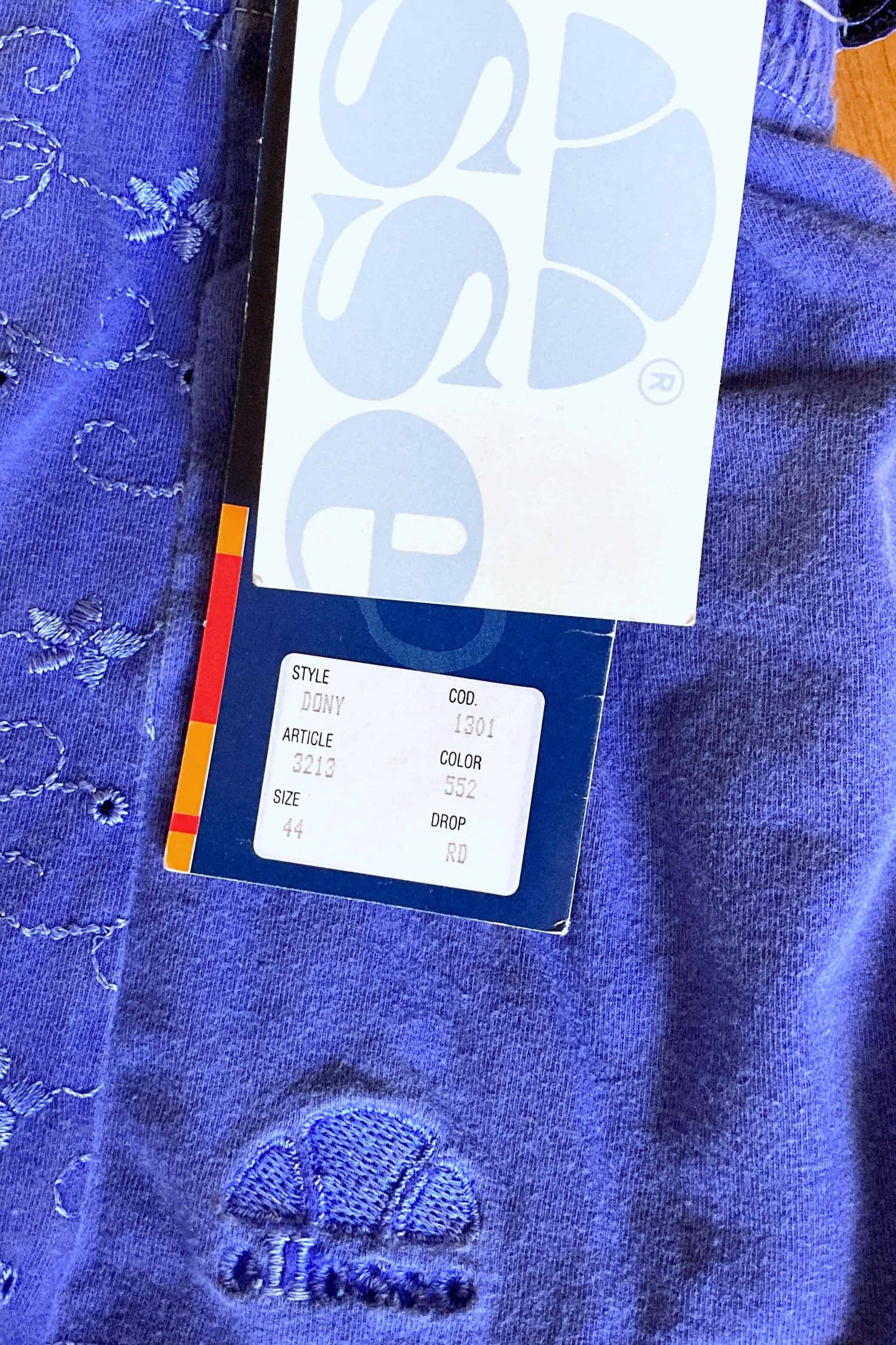 Closeup of Ellesse tag showing product code, style, and size information.