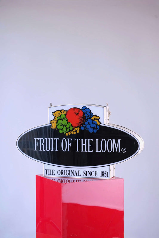 Front view of vintage 1990s Fruit of the Loom neon light-up store sign with classic logo and slogan “The Original Since 1851.”