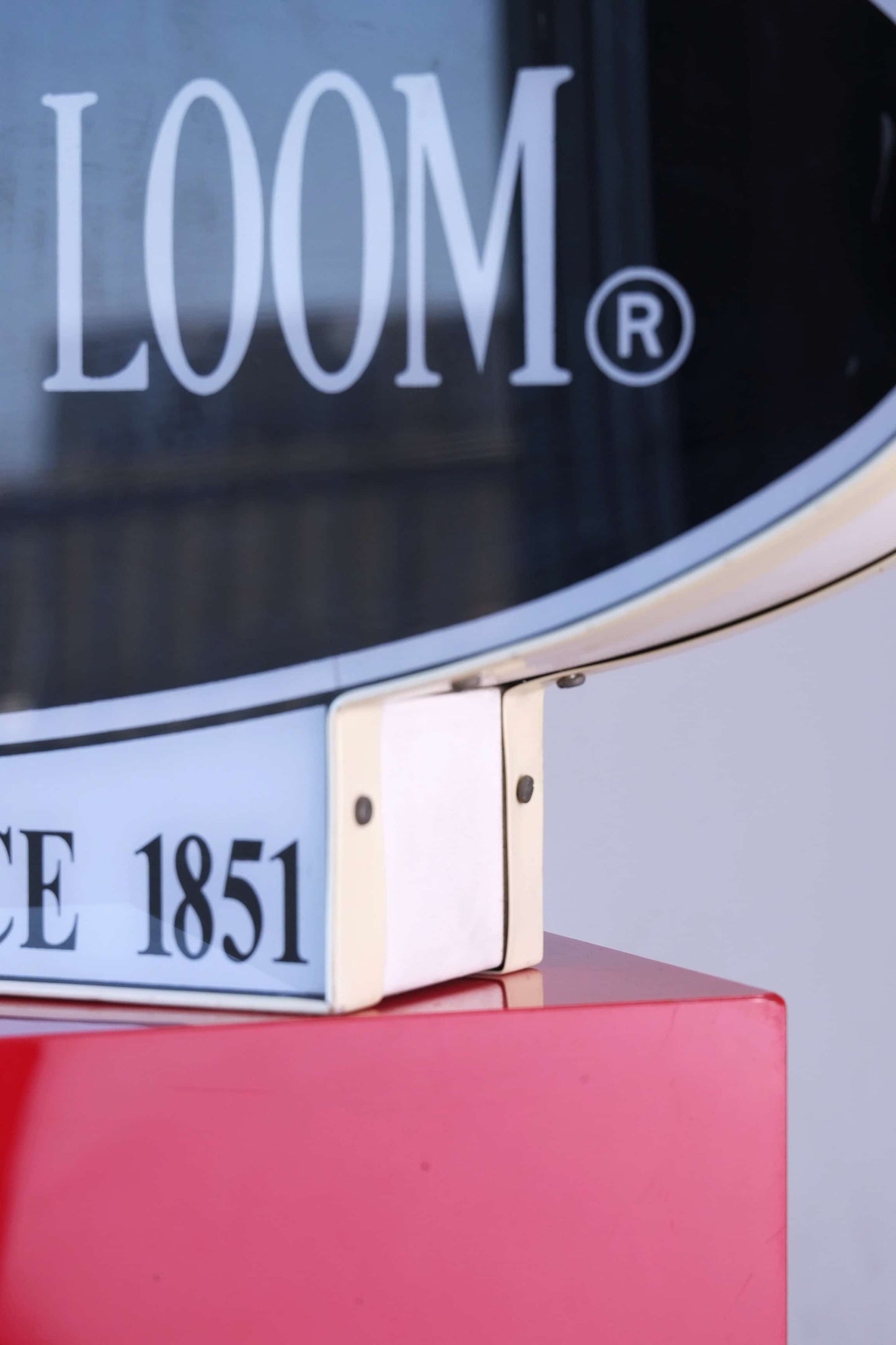 Bottom corner detail of Fruit of the Loom vintage neon light sign showing “The Original Since 1851” text and frame joints.