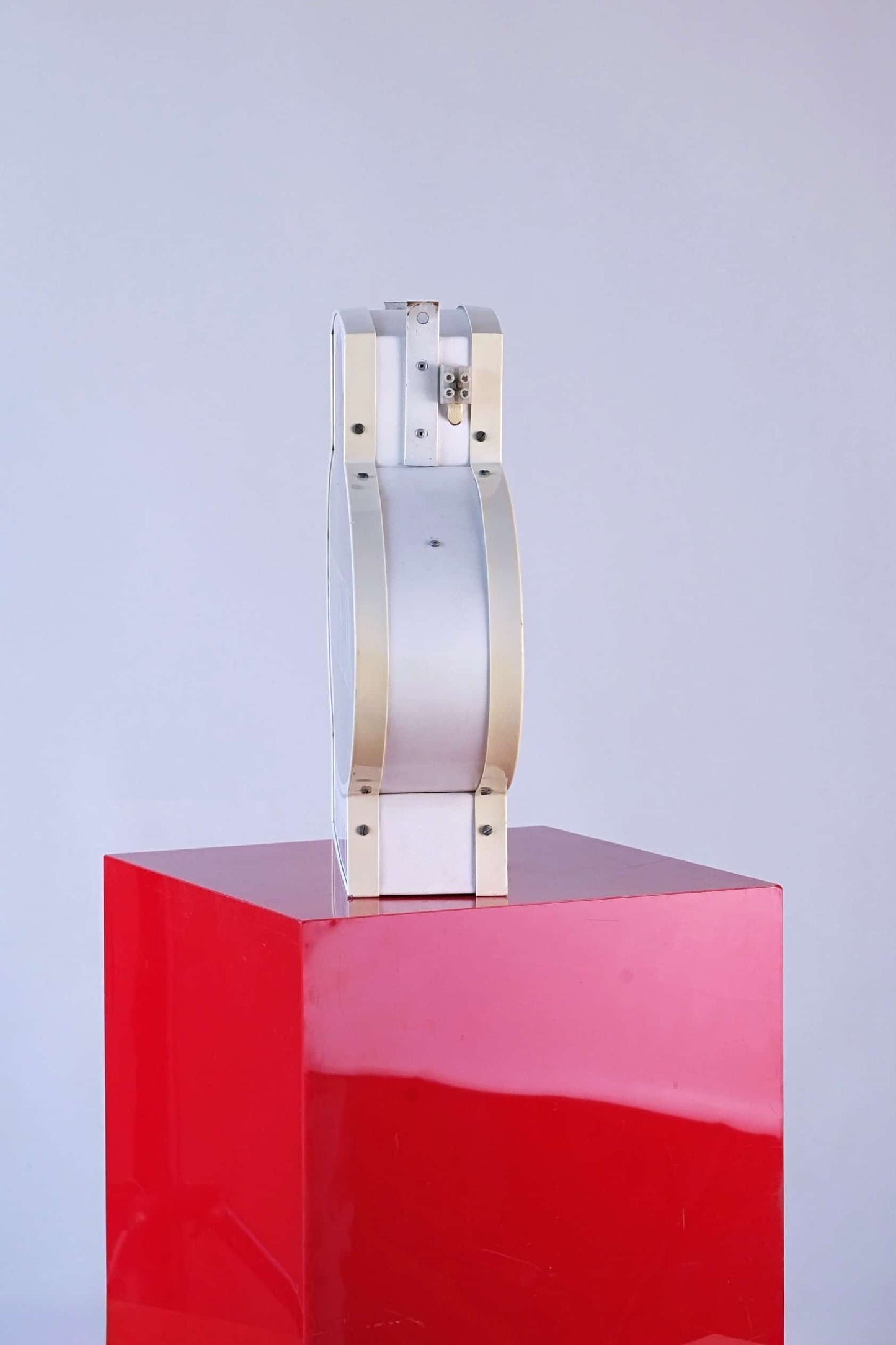 Side profile of Fruit of the Loom vintage 1990s neon light sign showing metal frame and curved construction.