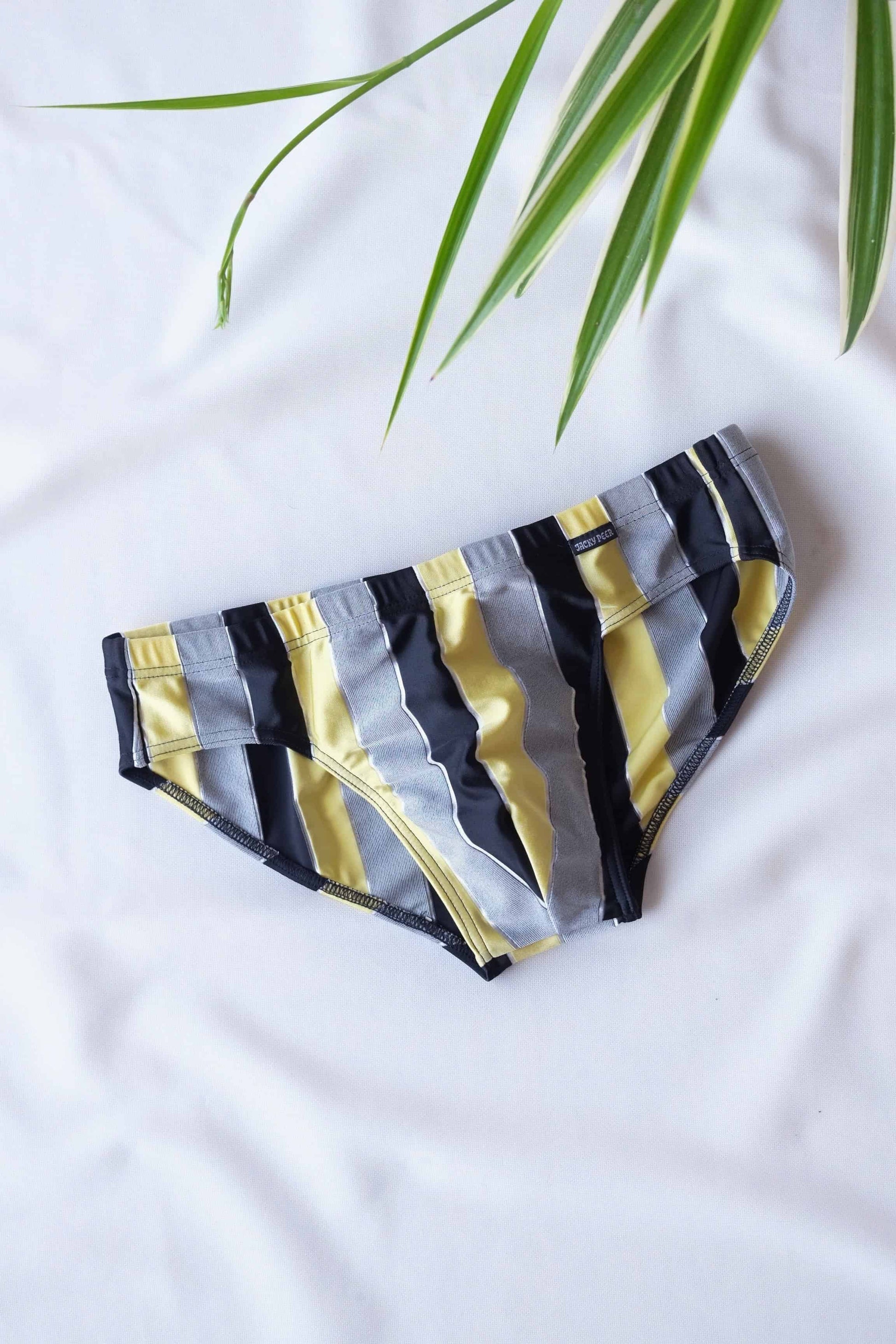 JACKY PEER Vintage black, grey and yellow Striped Swim Briefs displayed on white background.