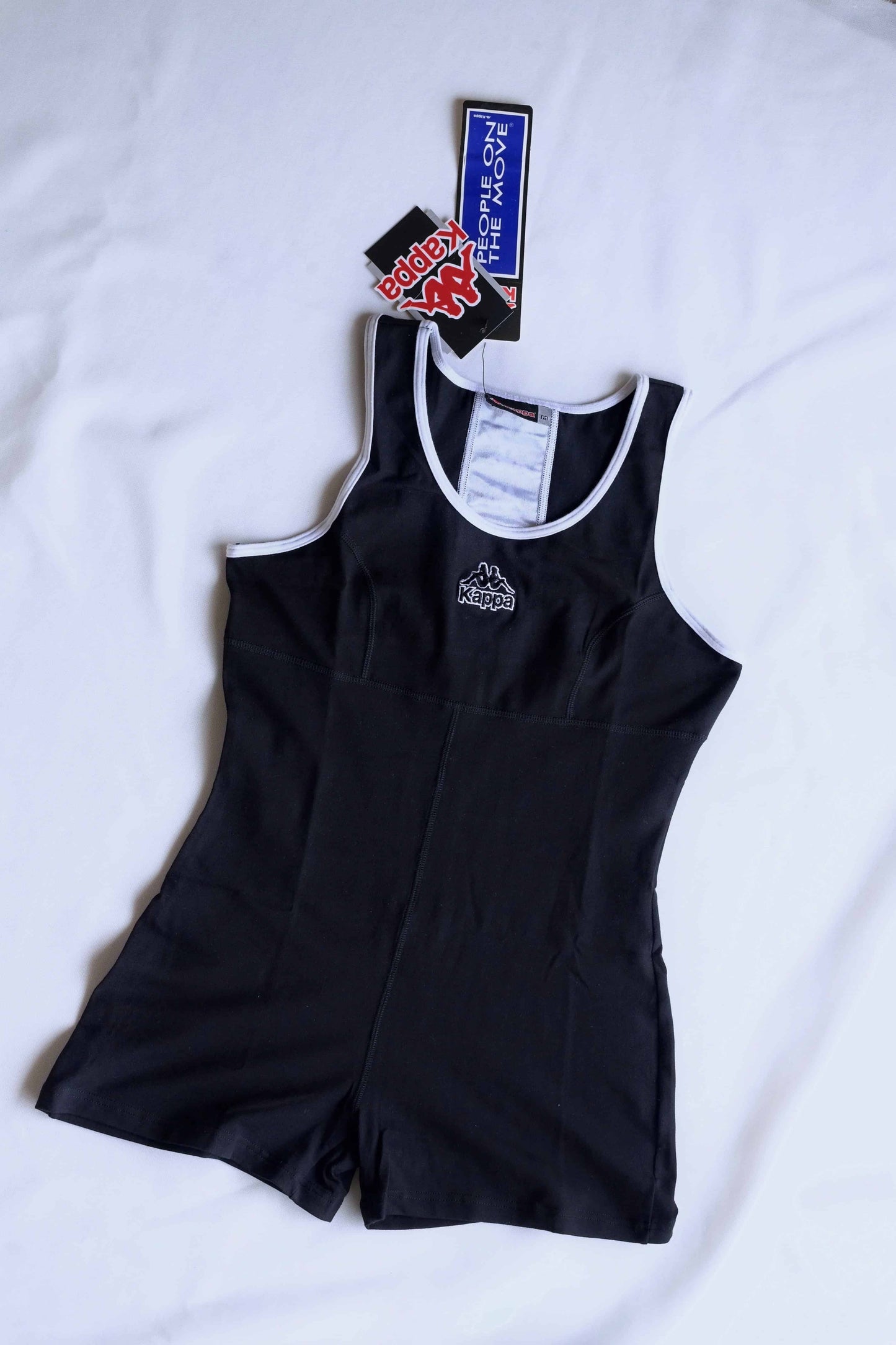 A black KAPPA vintage 90s women's activewear biketard with white trim and a KAPPA logo on the chest, laid flat with original tags visible.