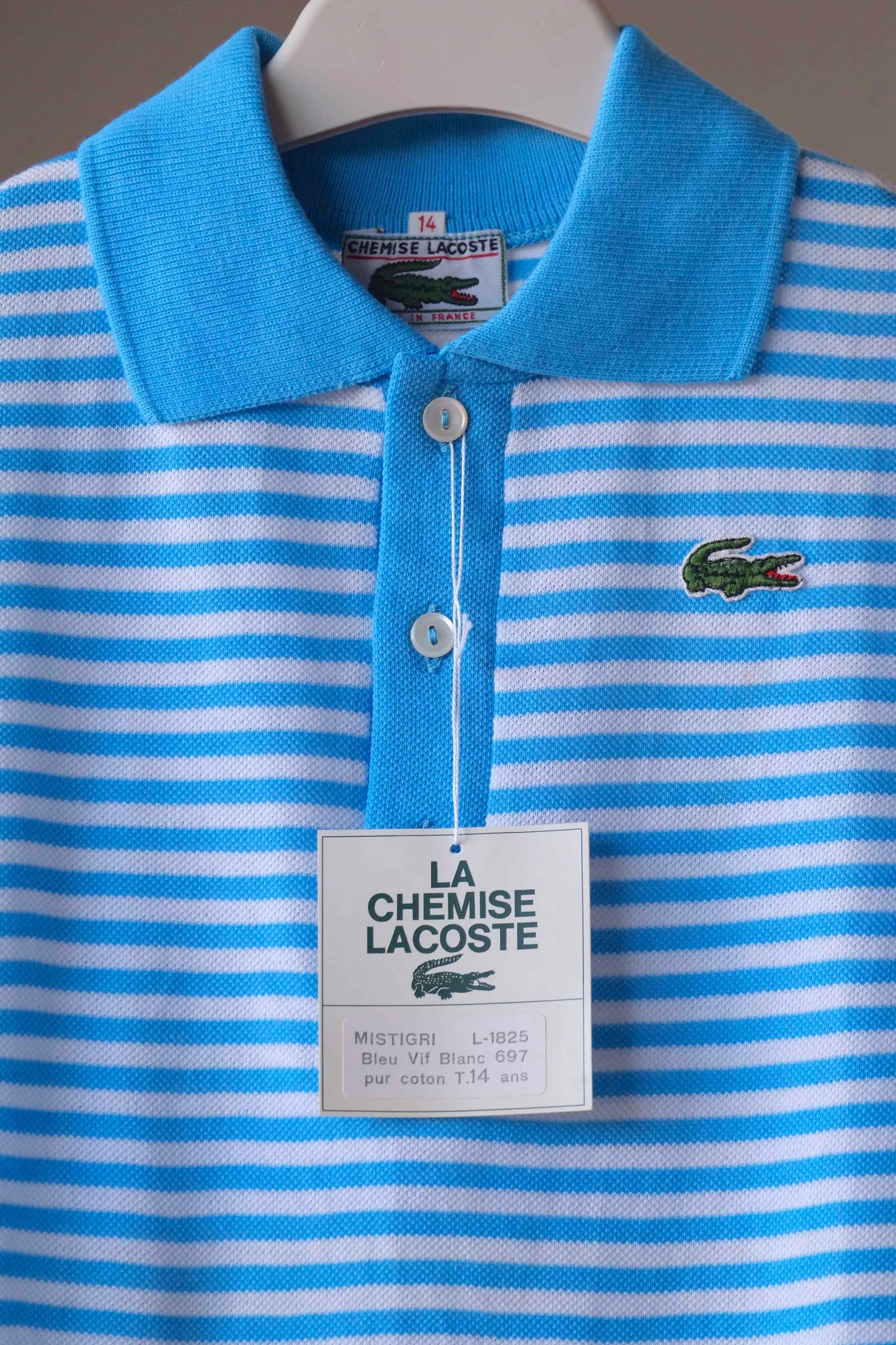 LACOSTE Kids Polo in white and bright blue stripes on hanger with paper label showing