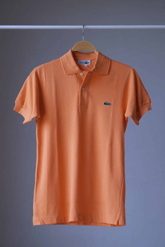 LACOSTE Retro Shirt in peach orange color on hanger