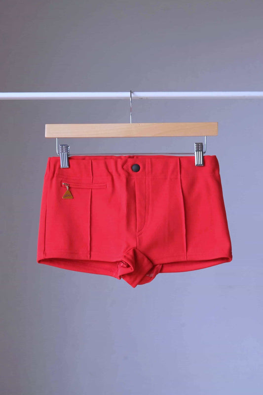 Red Vintage 60s Lahco Mataro model swim trunks on hanger, showing structured waistband and minimalist design.