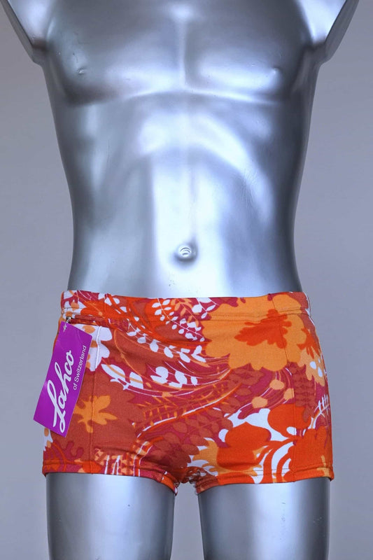 Front view of LAHCO vintage 60s “Rovigo” swim trunks with orange, red, and white floral print, shown on mannequin with original tag.