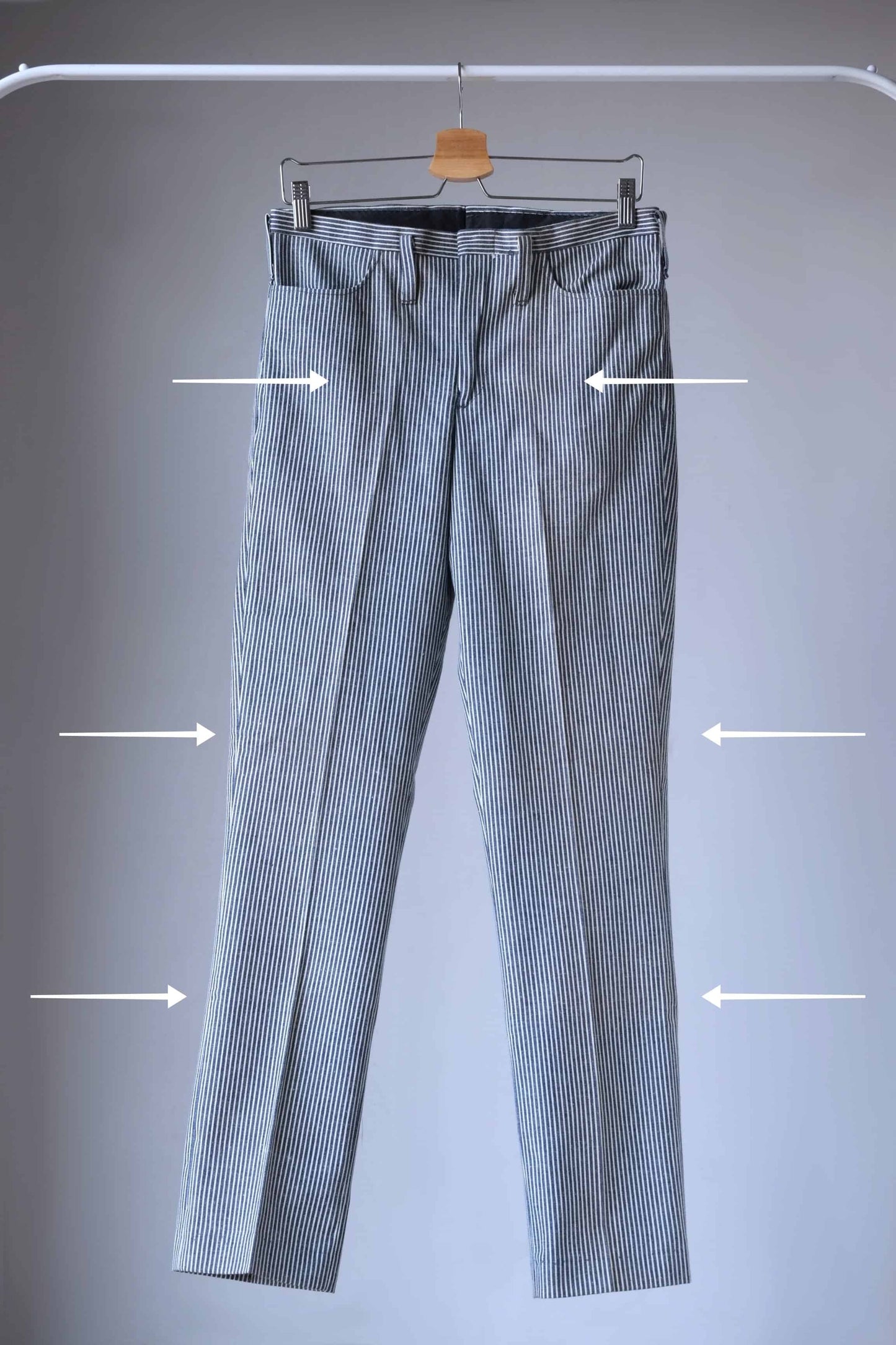 LEE 60's Vintage Tapered Slim Pants black and white stripes, on hanger, front view, with arrows pointing to stains