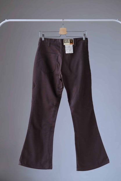 Back view of a pair of Brown Vintage Lee flared pants on hanger