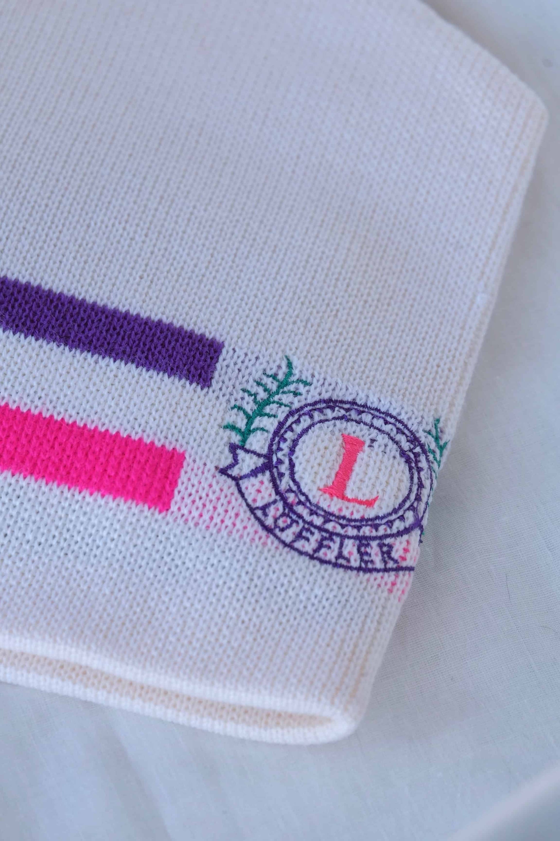 LÖFFLER Retro Snow Beanie white with neon pink and purple lines details