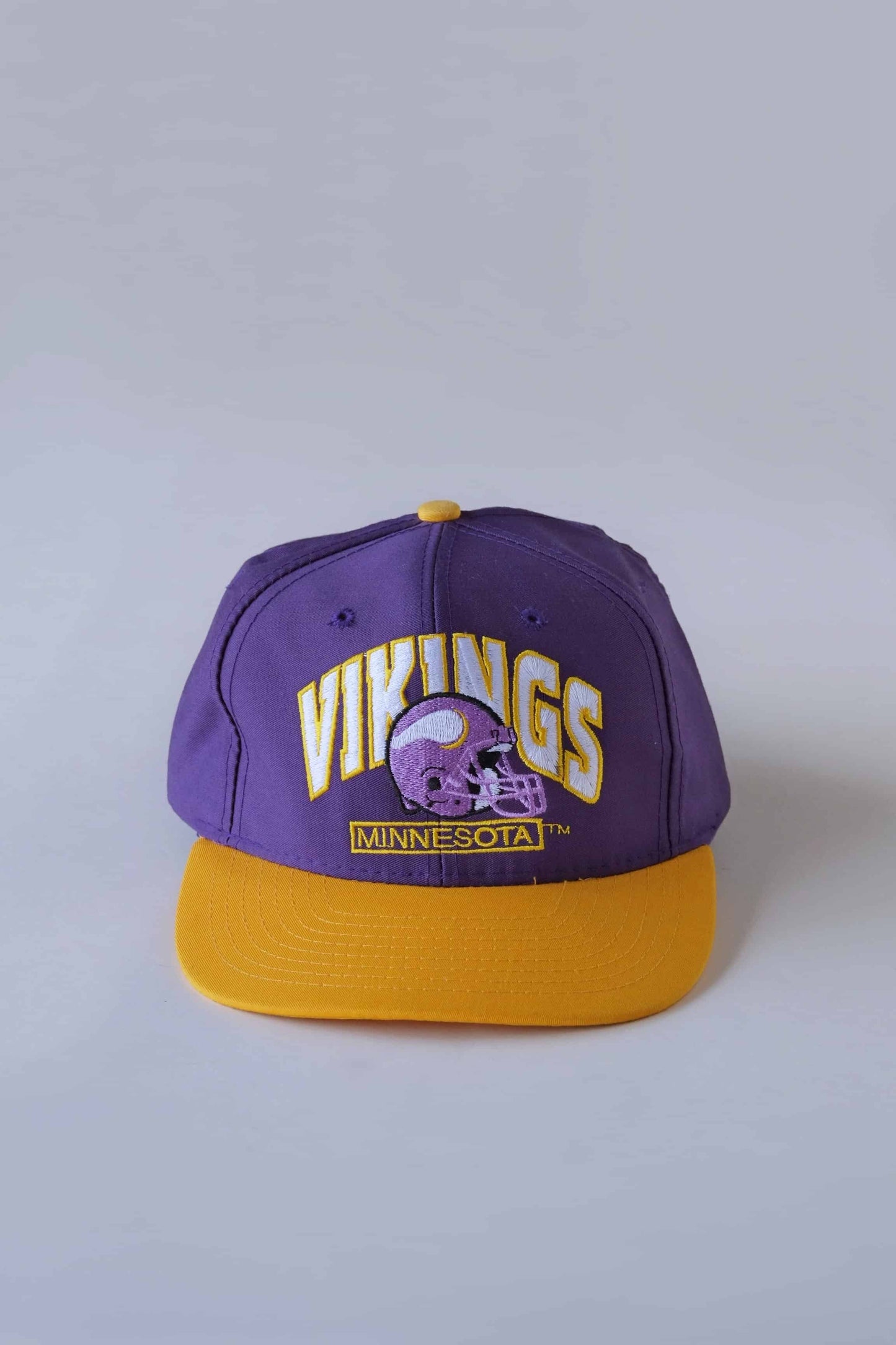 purple and yellow minnesota vikings nfl snapback hat on white background