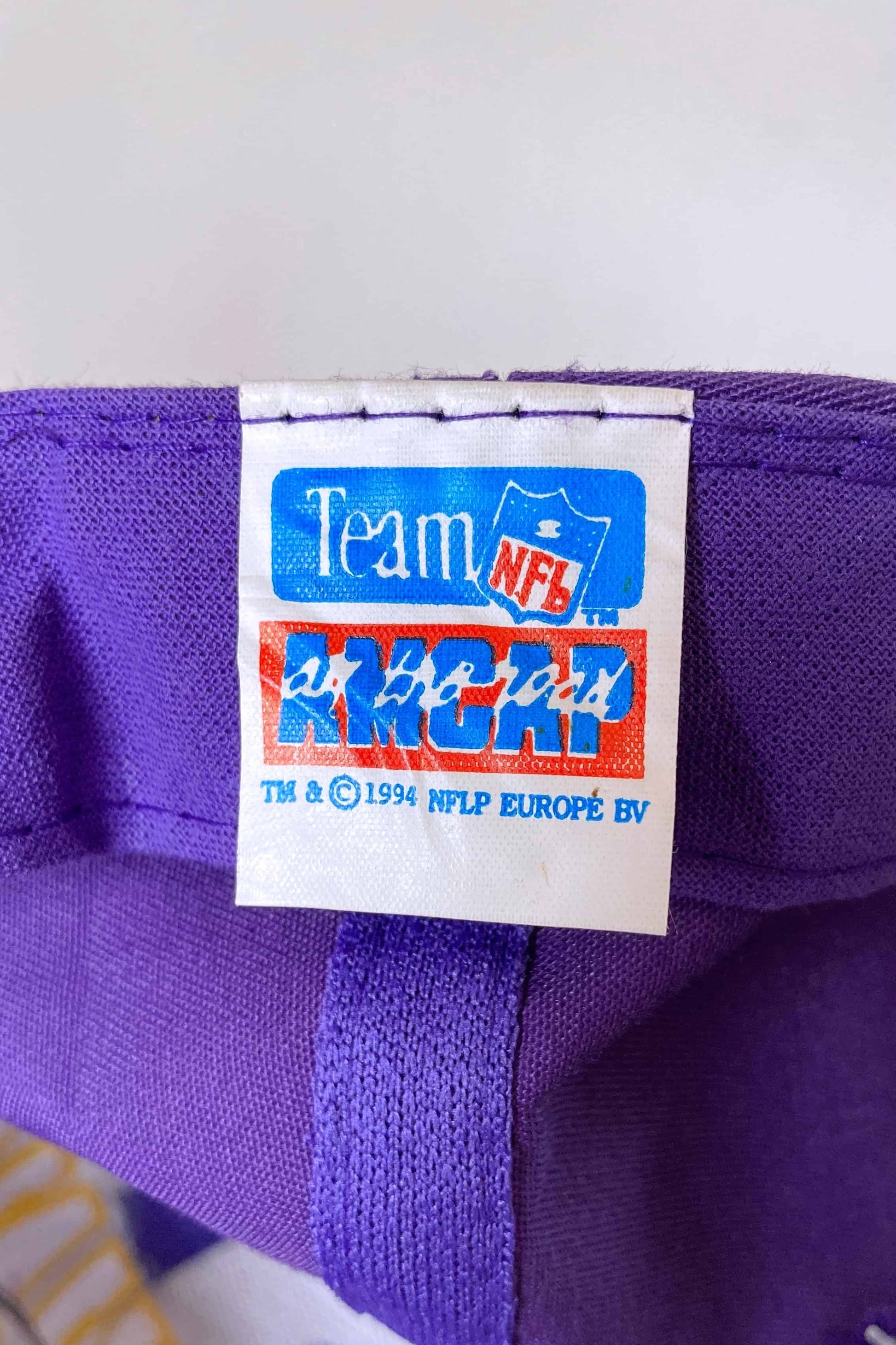 close shot of the label inside a purple NFL hat