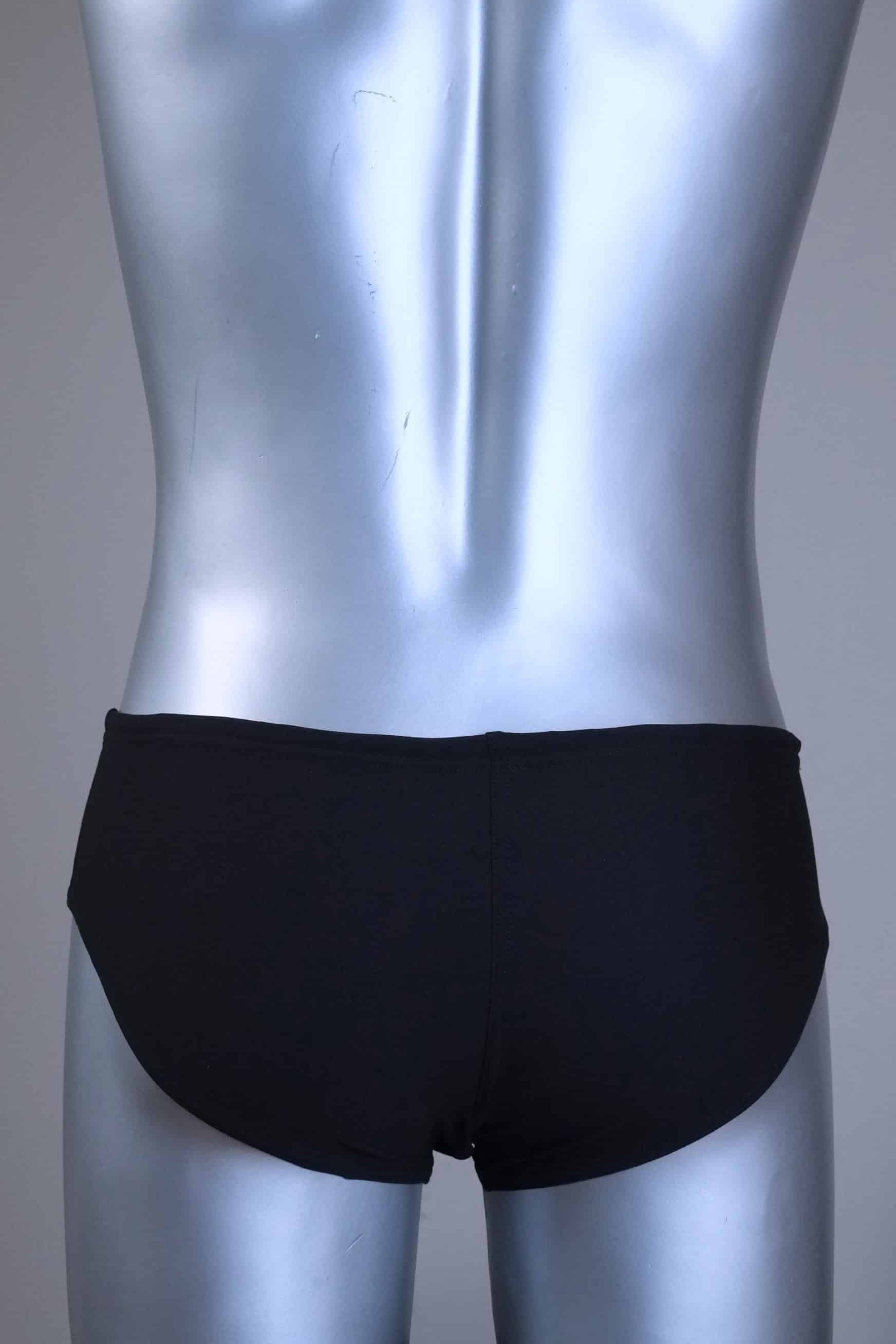 Back view of a pair of a Vintage Black men's swim briefs with white stripes on a metallic mannequin against a gray background