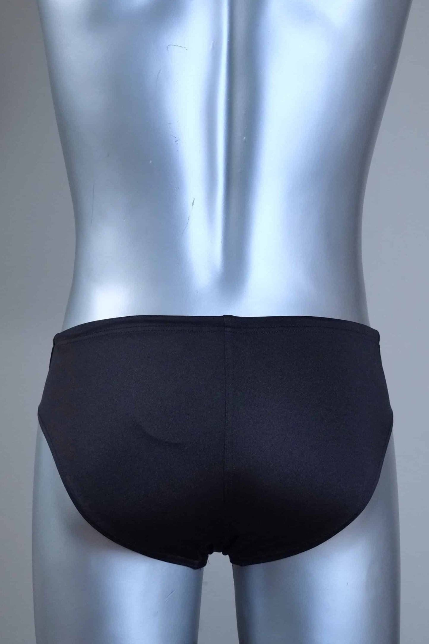 Back view of a pair of SOLAR vintage 70s swim briefs in black shown on a silver mannequin