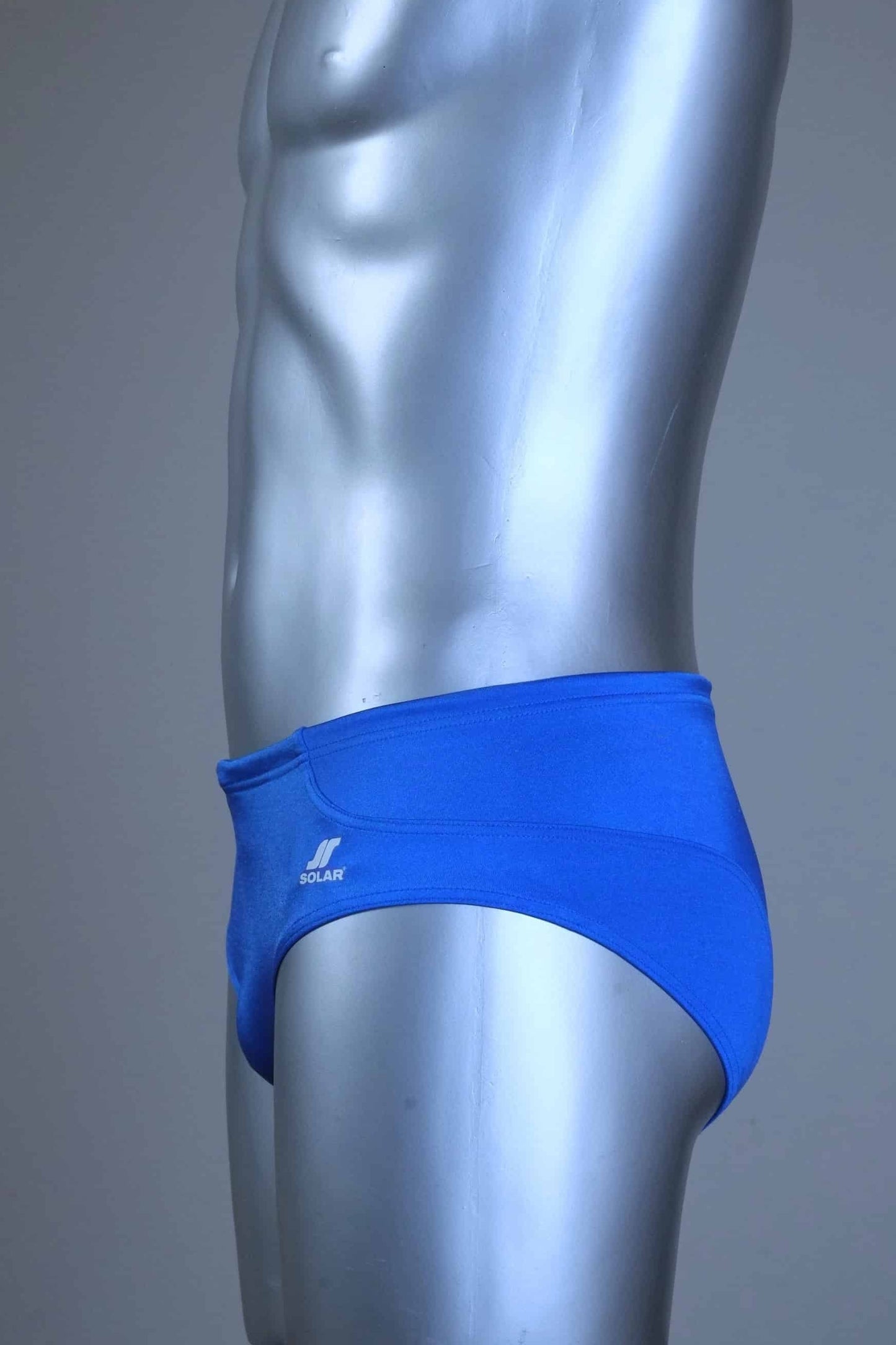 Side of a pair of SOLAR vintage 70s swim briefs in royal blue shown on a silver mannequin