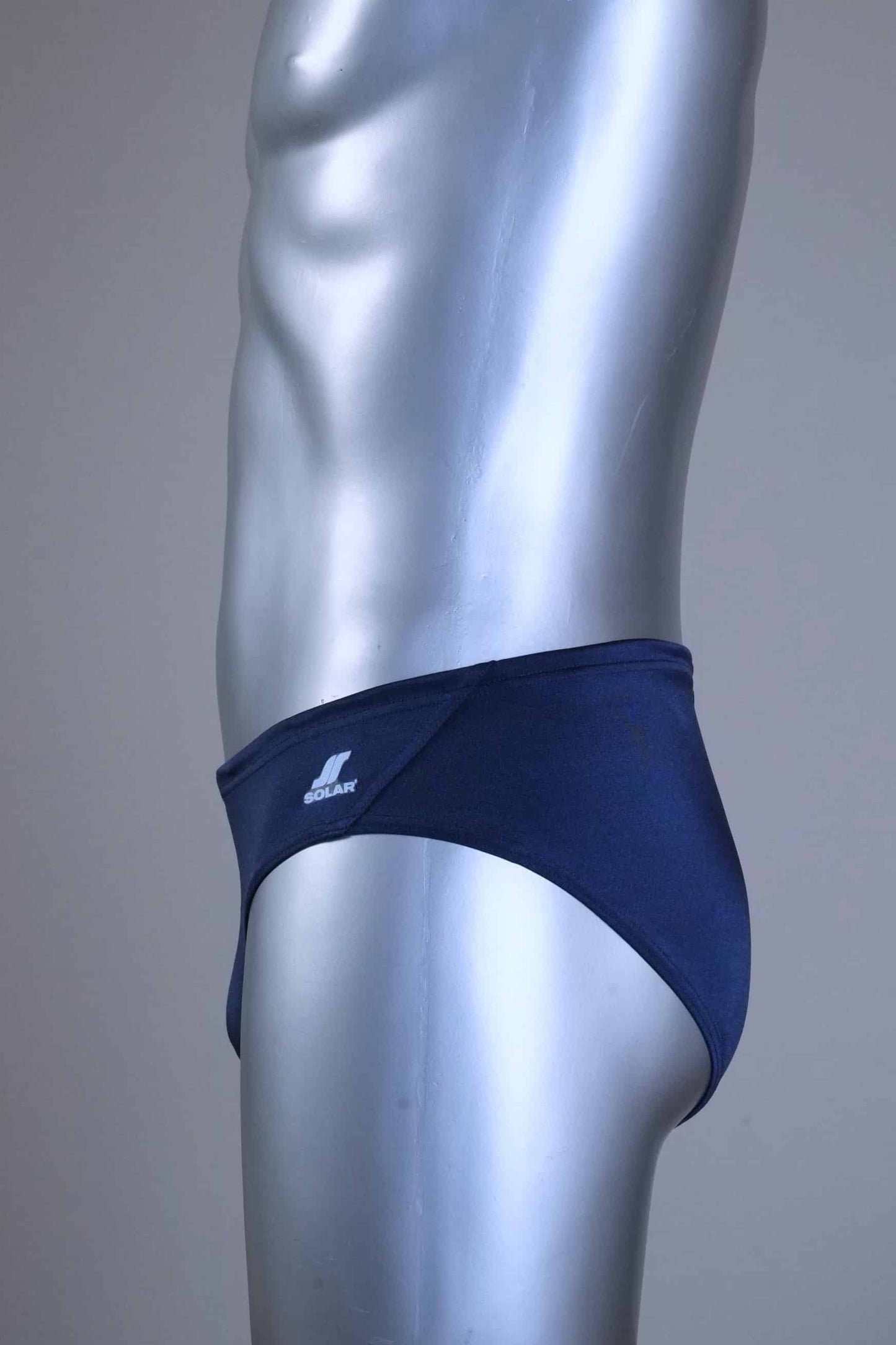 Side of a pair of SOLAR vintage 70s swim briefs in navy shown on a silver mannequin