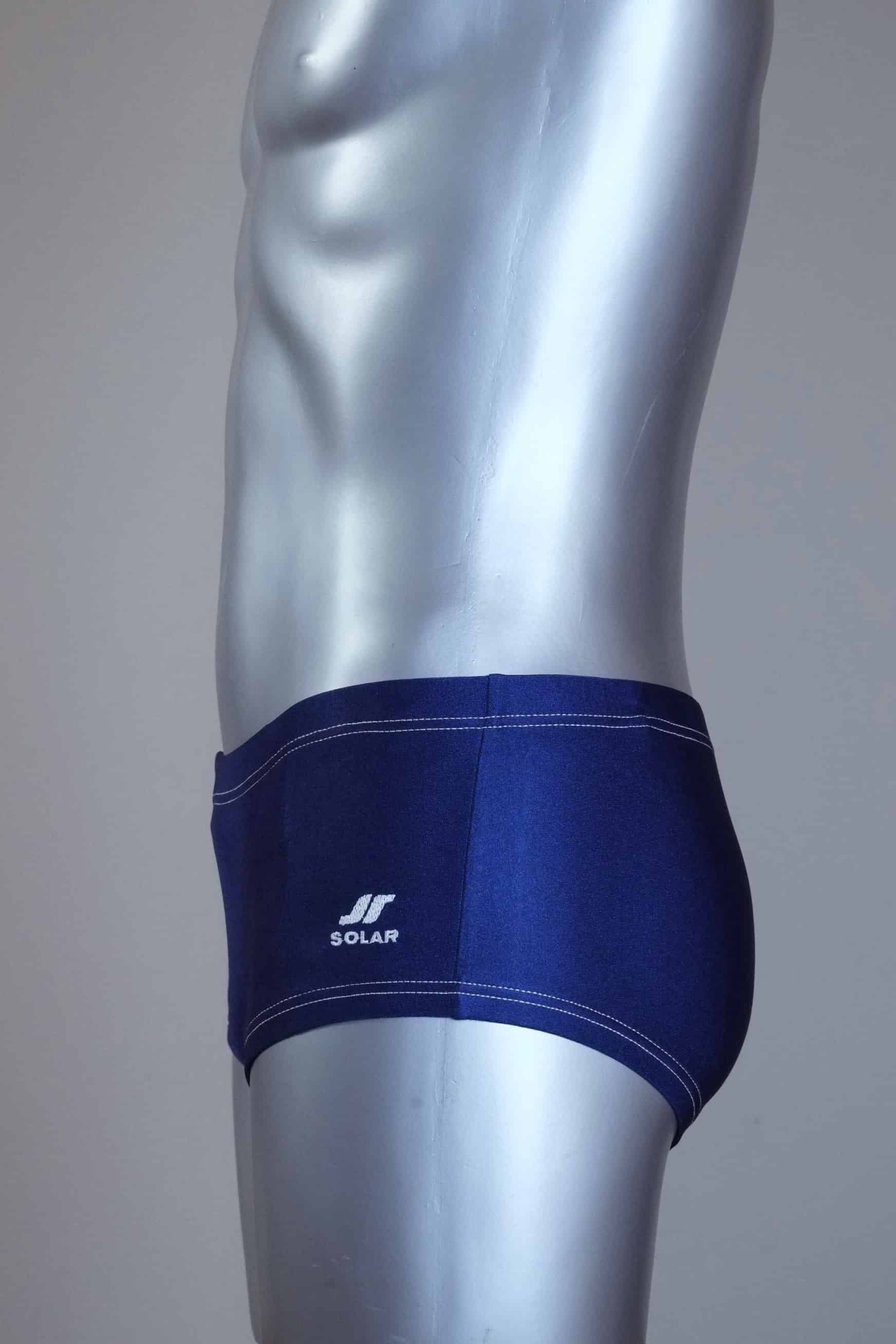 Side view of Vintage Blue and white swim briefs on a silver mannequin against a gray background
