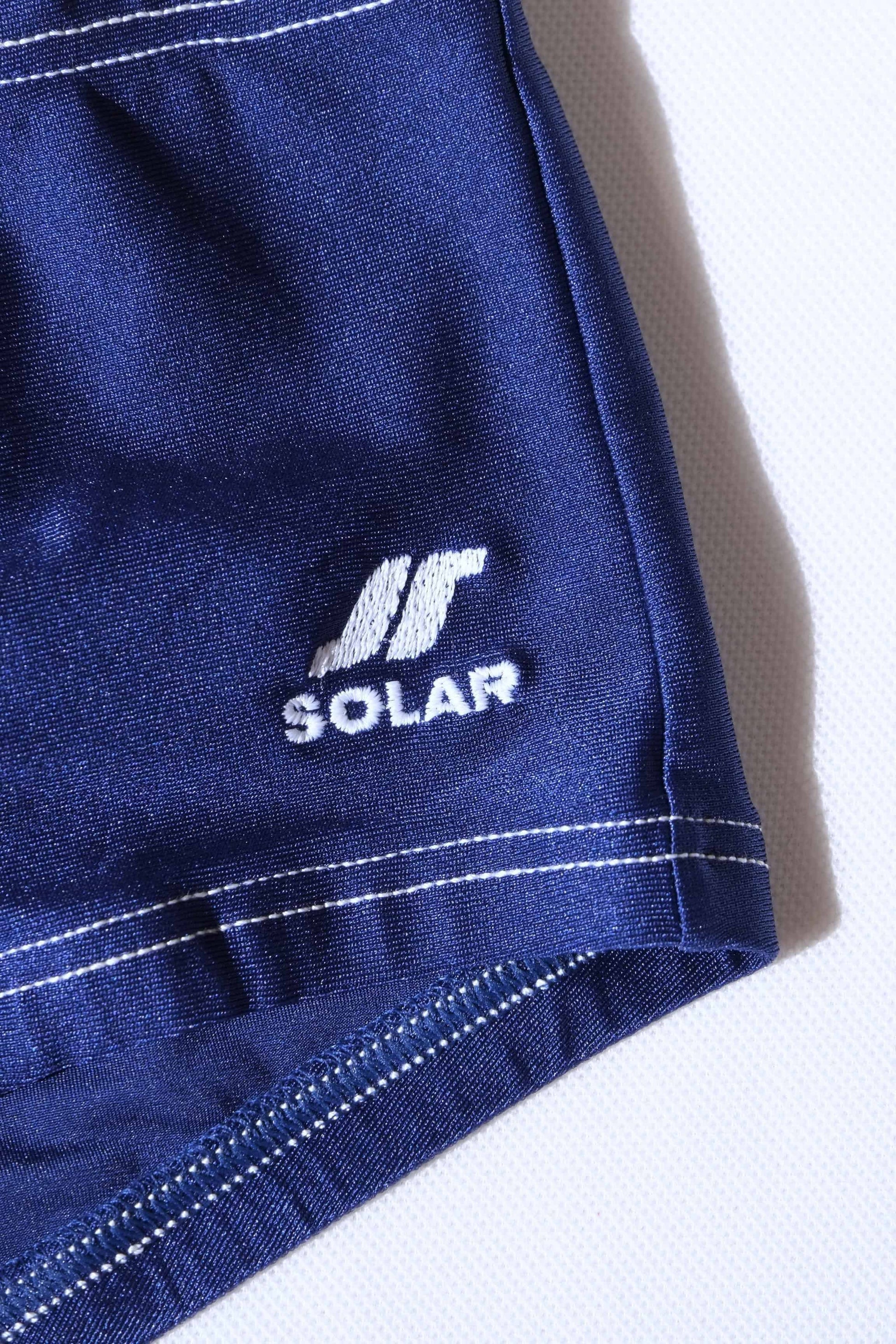 Close-up of a blue fabric with 'Solar' logo on a white background