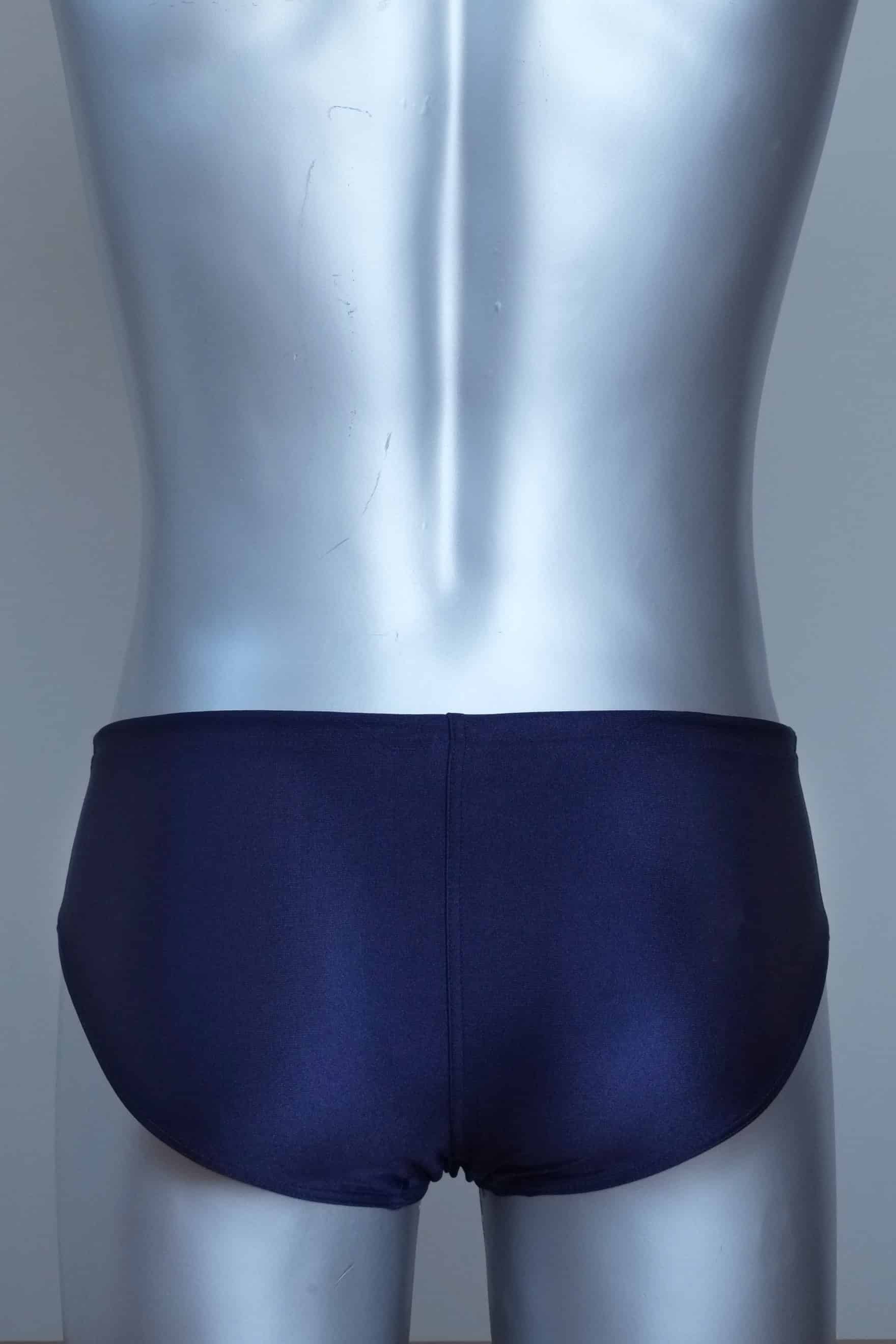 Back view of vintage navy swim briefs with mannequin against a gray background