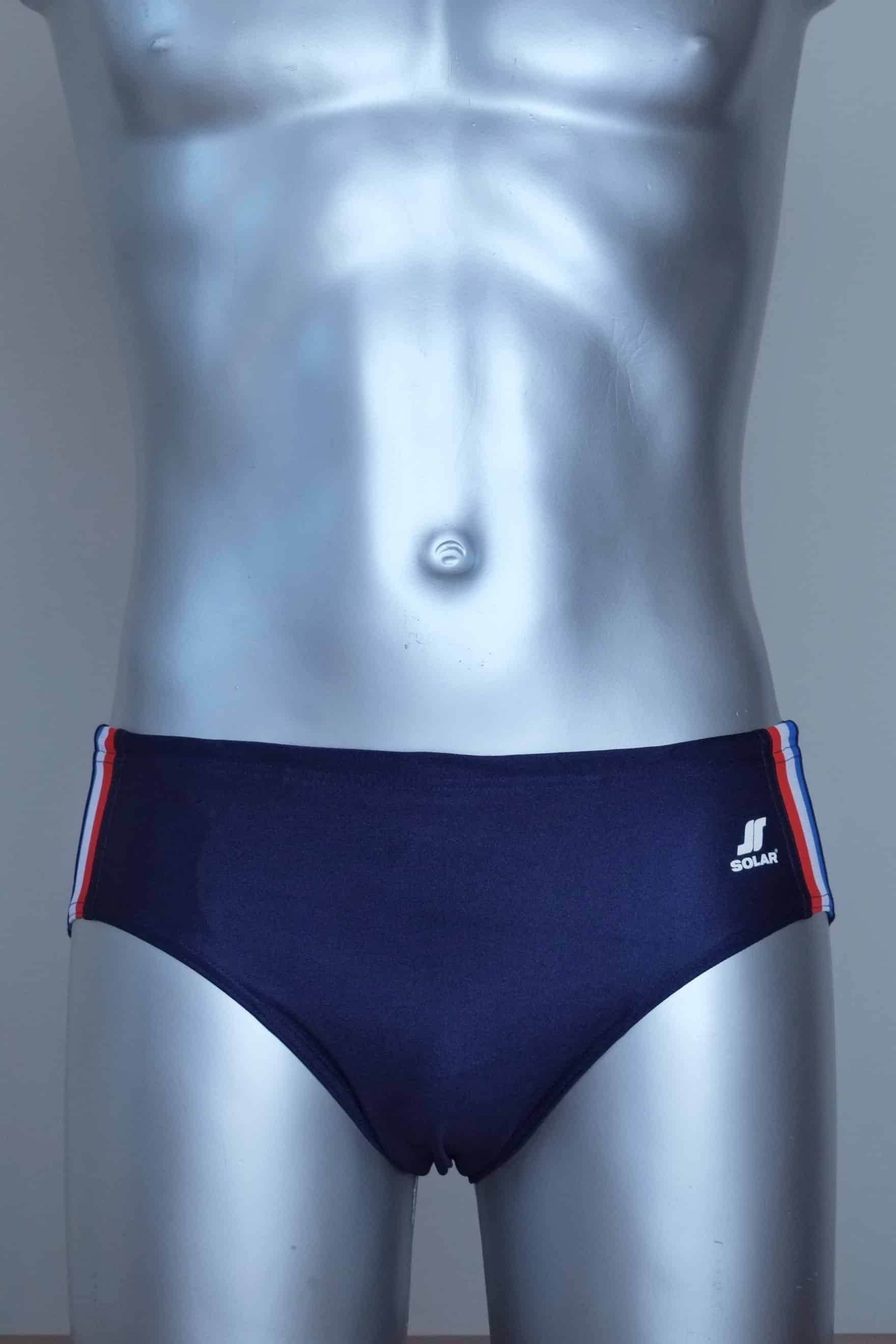 Navy swim briefs with colorful side band on a mannequin against a gray background