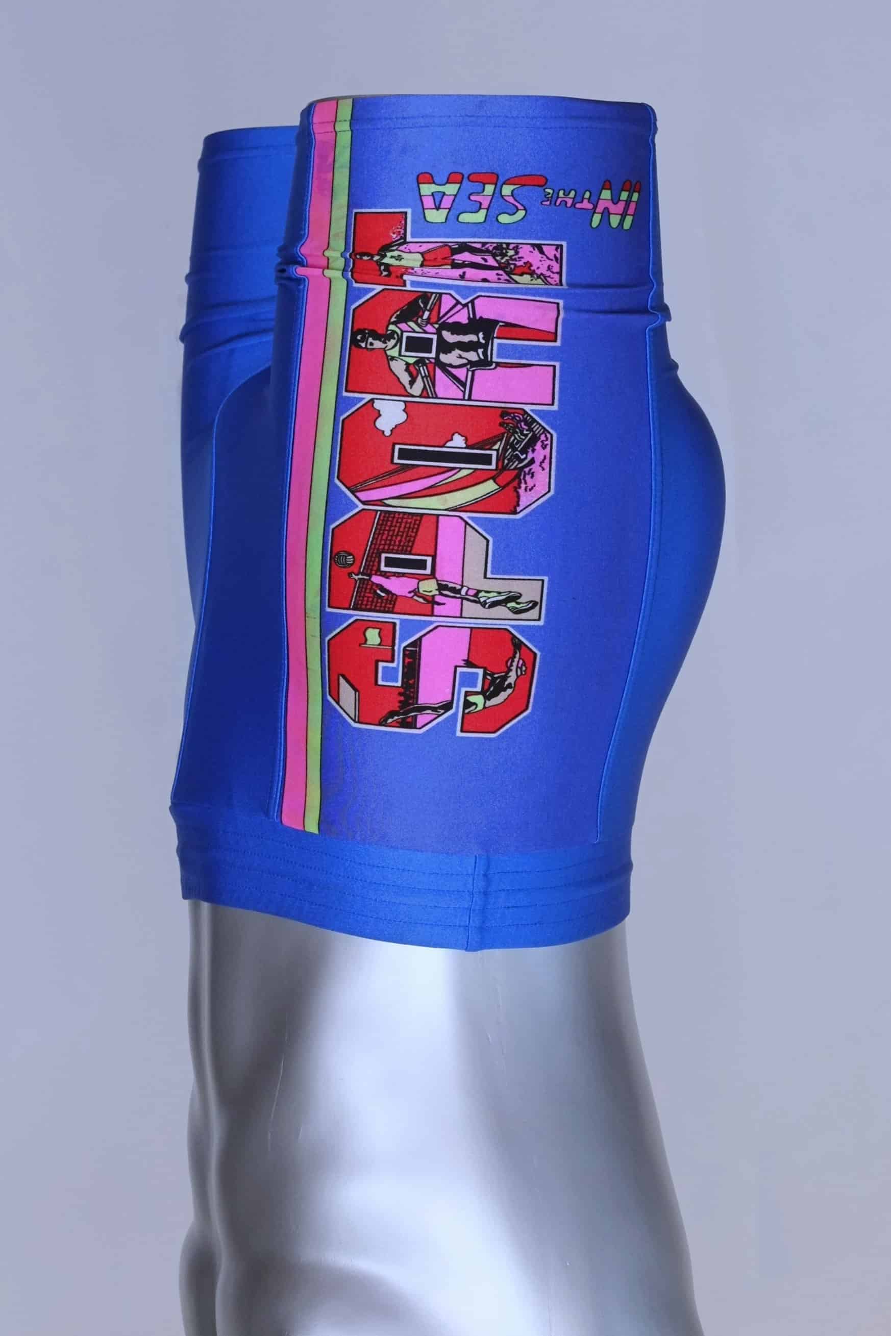 Side view of the blue vintage Sprider swim trunks on a mannequin, highlighting the colorful print and "SPORT IN THE SEA" text.