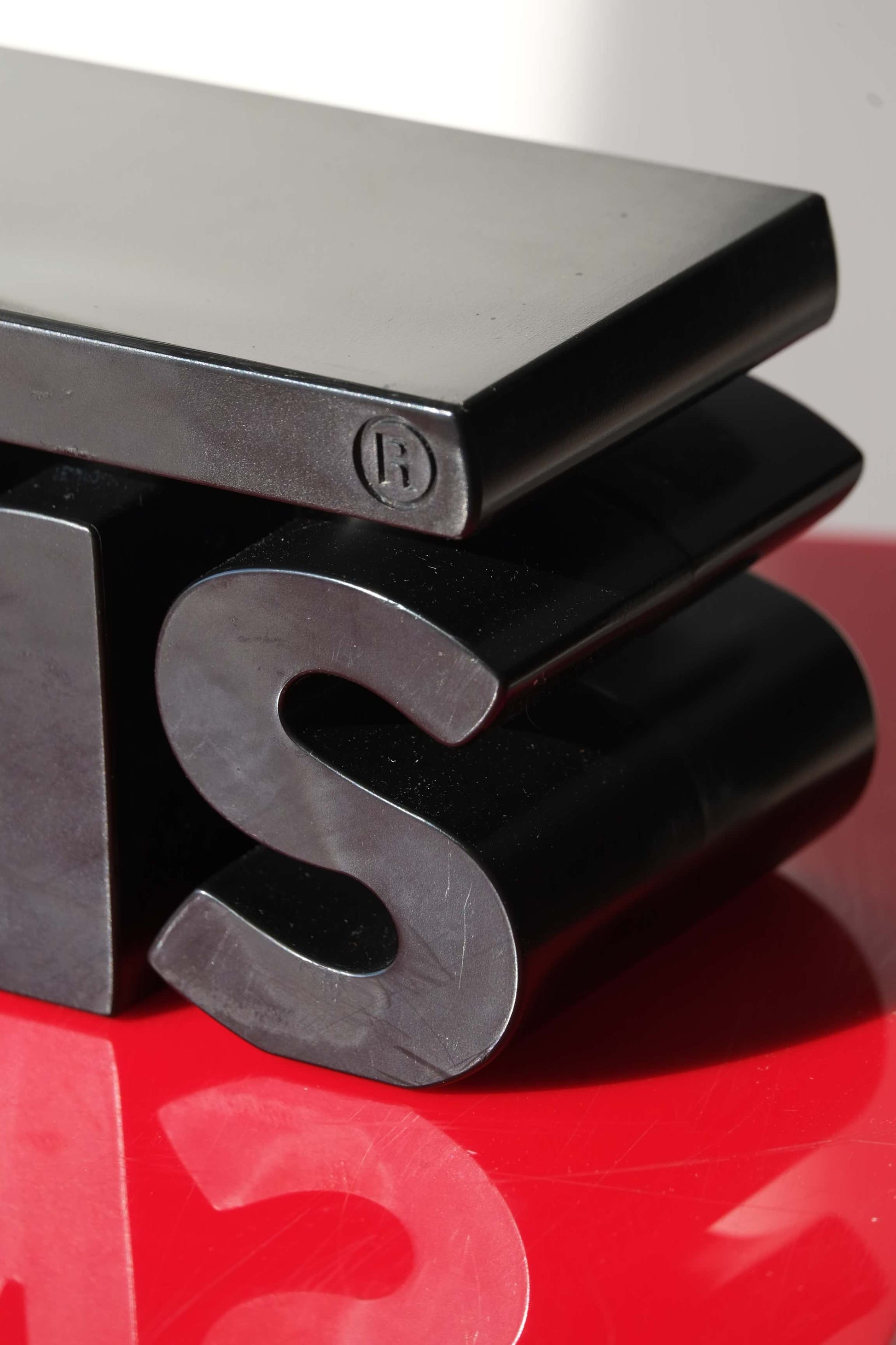 Close-up detail of the registered Vans Y2K dealer display sign showing embossed logo edge and smooth matte finish.