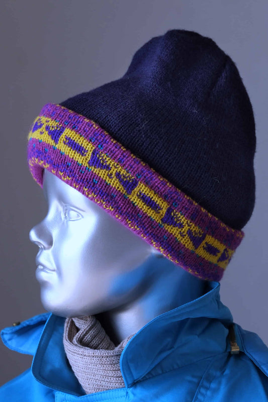 WOOL Kids Beanie in navy and a purple/yellow jacquard cuff on mannequi