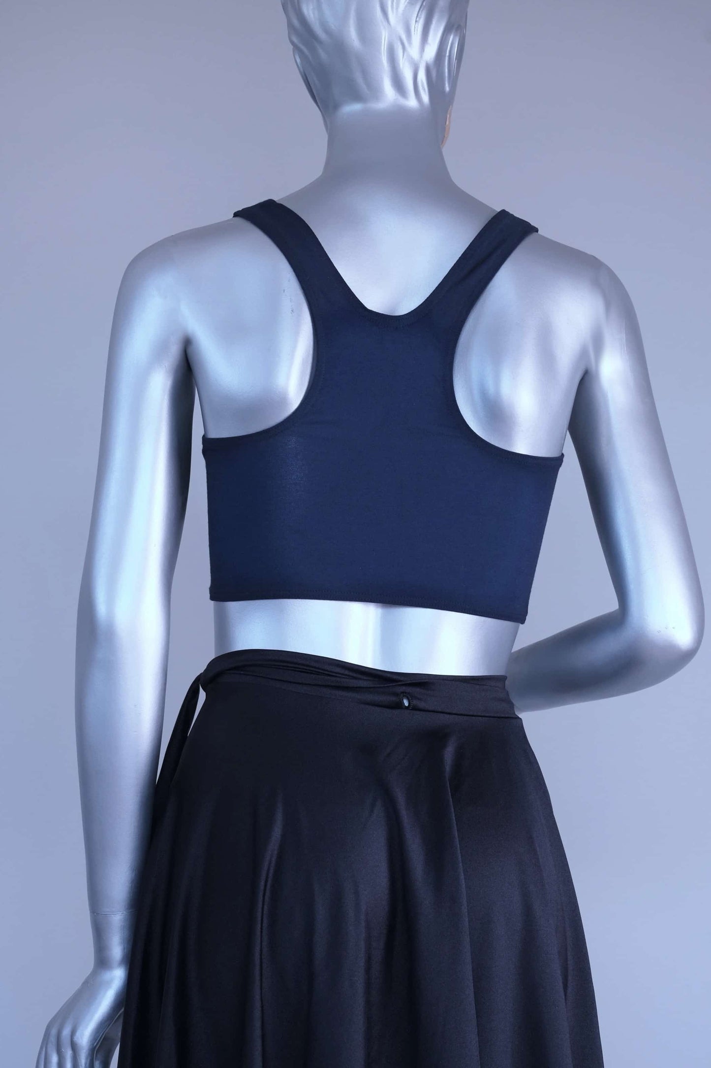 Back view of a Mannequin wearing a navy crop top against a plain background