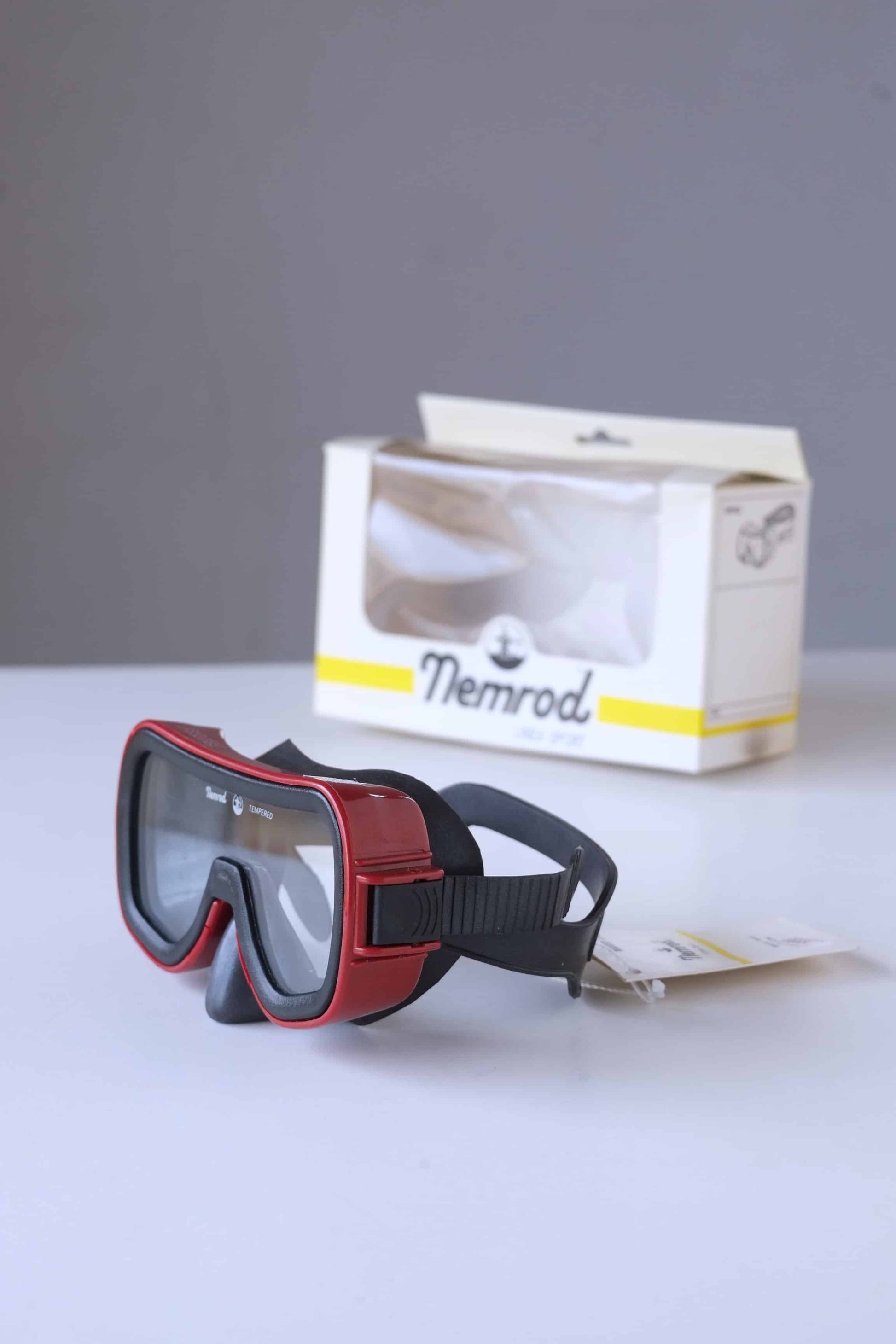 NEMROD Brisa 90's Diving Mask red and black with box behind it