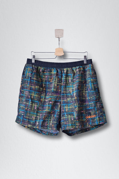 Front view of black ADIDAS vintage 2000s men's swim shorts with a multi-color abstract pattern. 
