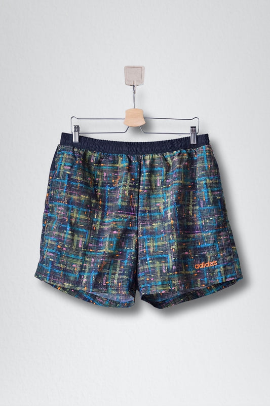 Front view of black ADIDAS vintage 2000s men's swim shorts with a multi-color abstract pattern. 
