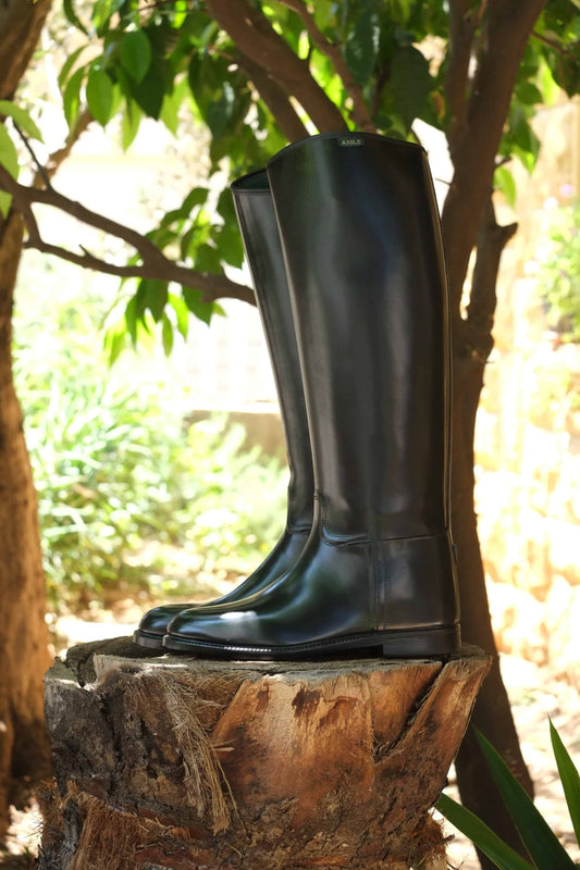 AIGLE Start Horseback Riding Boots photographed outside on a tree trunk