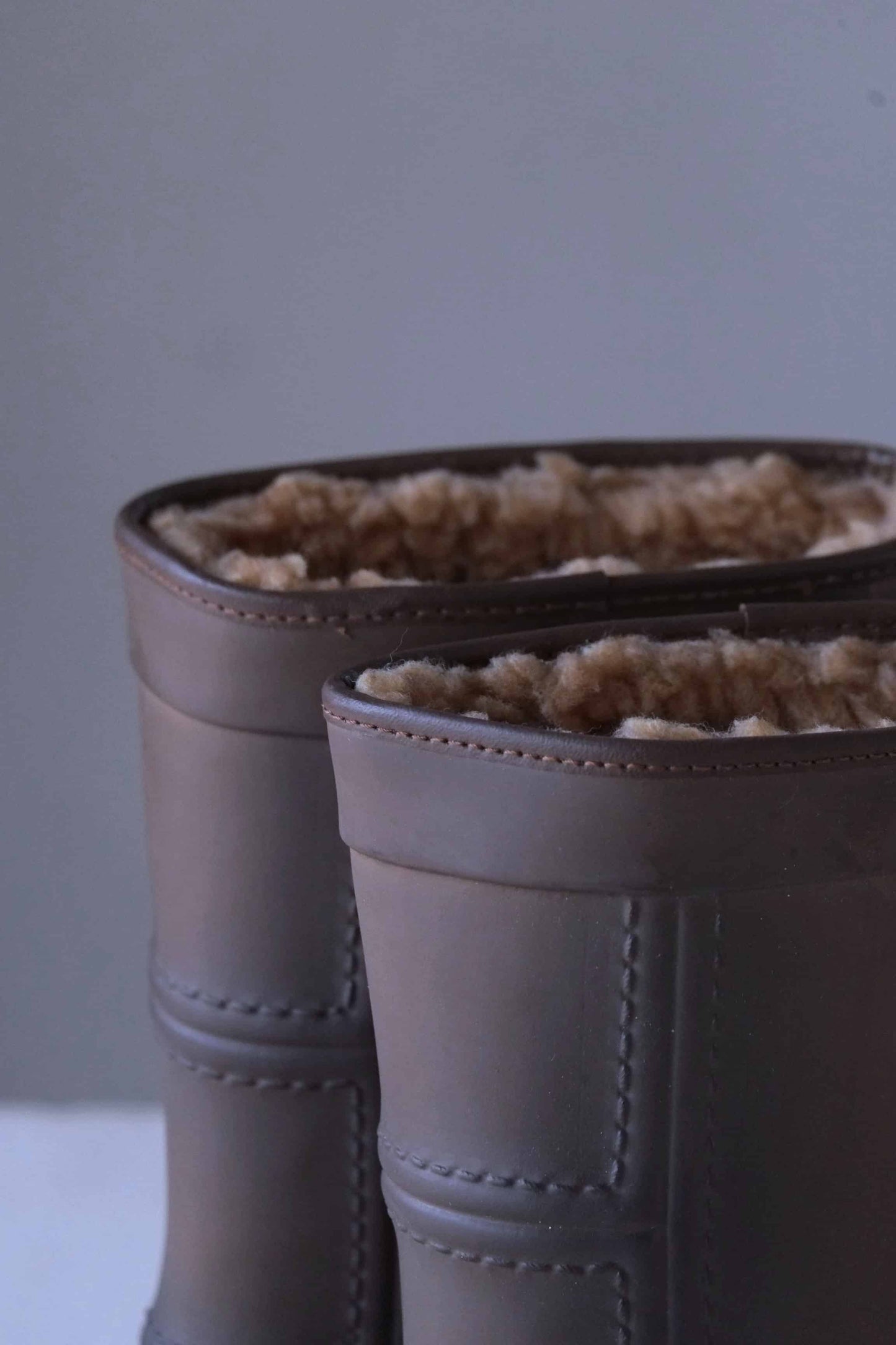 Close view of shearling wool lining of Aigle brown rubber snow boots