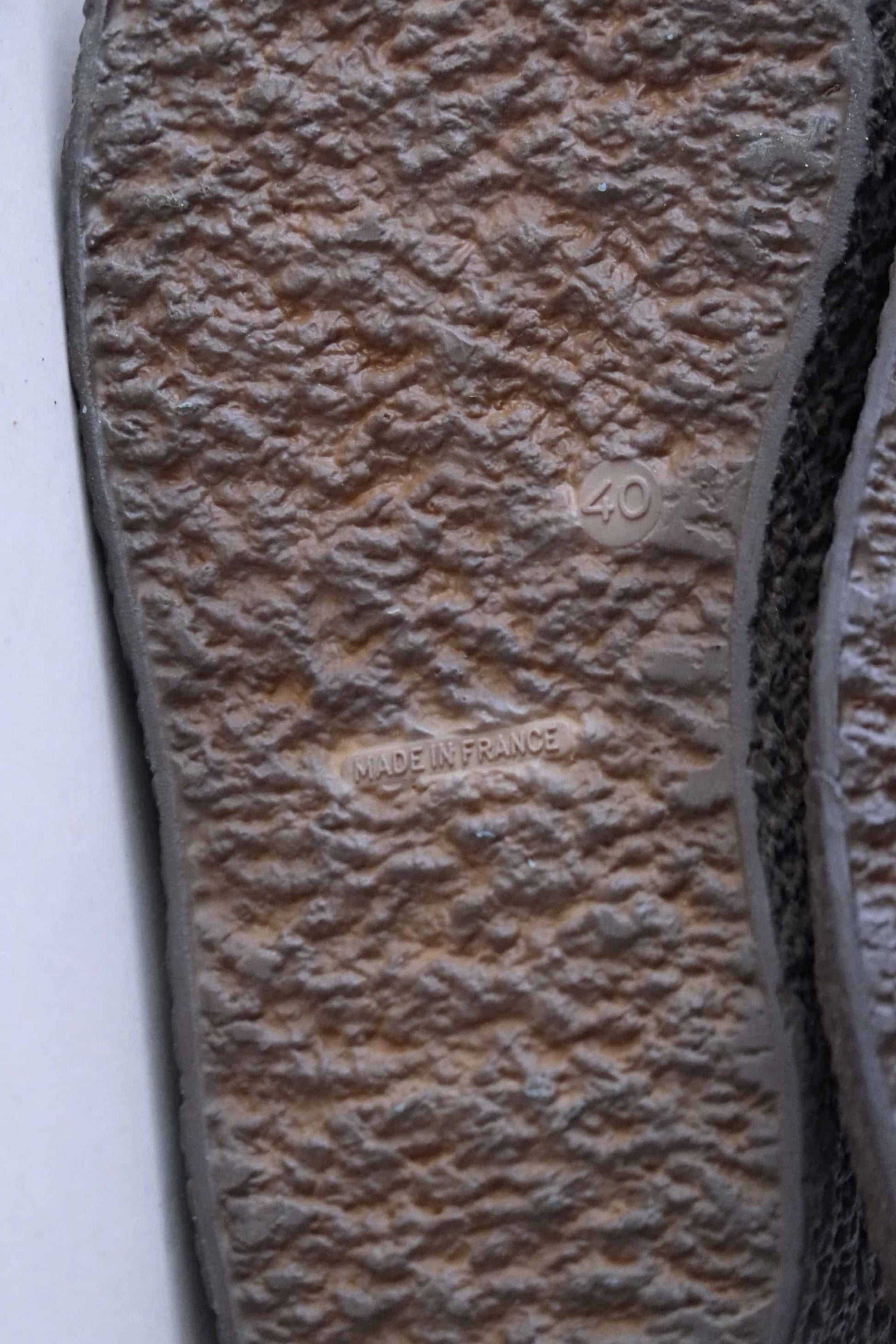 close up view of the crepe soles of vintage brown rubber boots