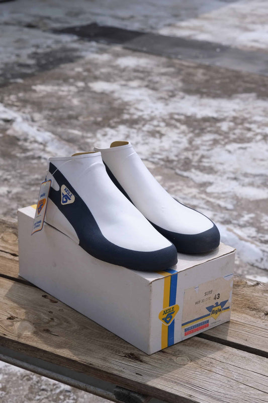 Vintage Aigle Surf Boots placed on their original box outside on a bench