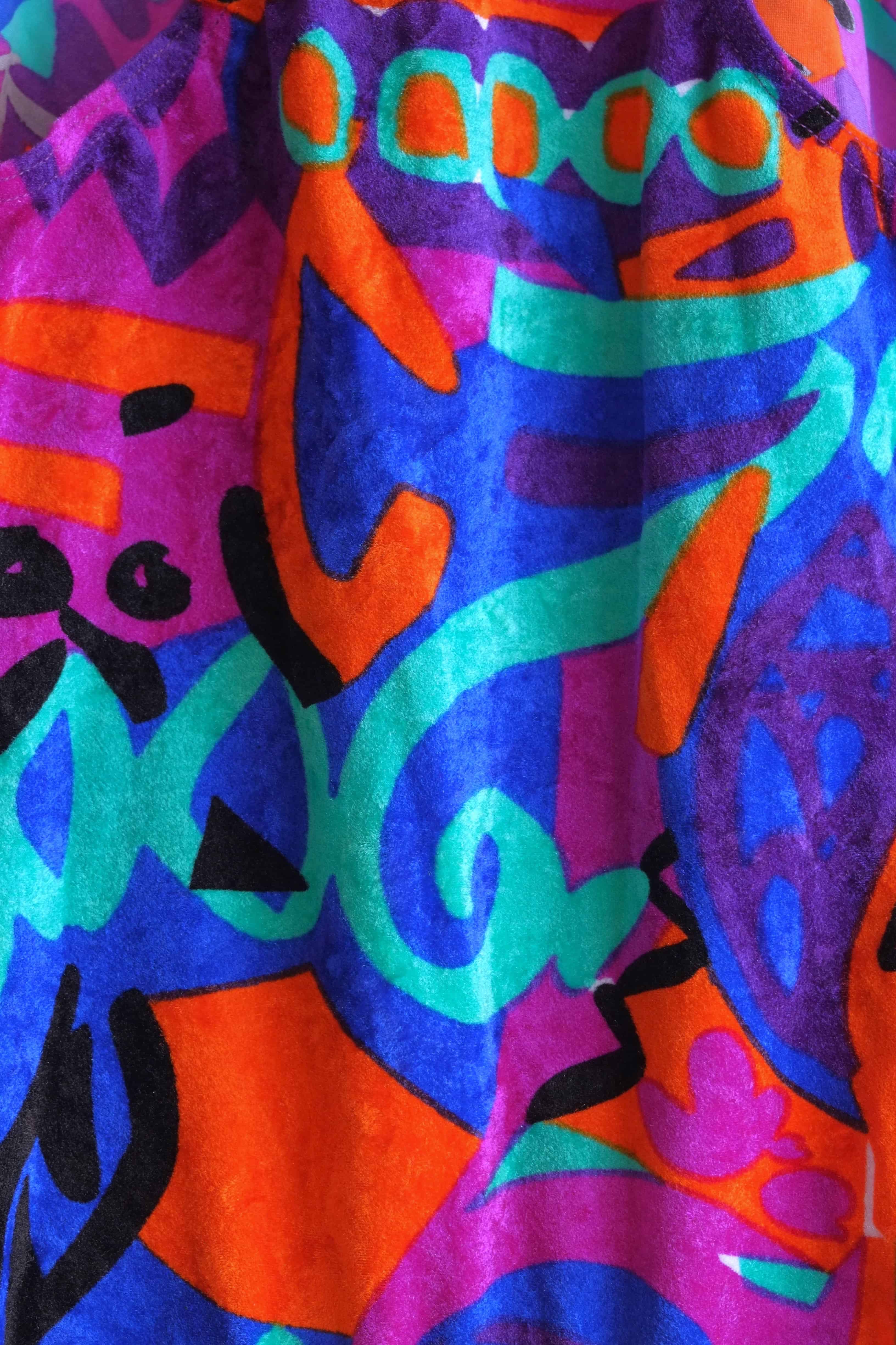 Close up of the fabric of a colorful vintage Anniel one-piece leotard.