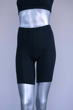 Back view of a mannequin wearing black vintage 90s Anniel cotton biker shorts.