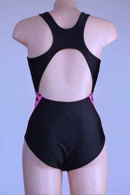 Back view of a vintage 90s Anniel black and neon pink one-piece swimsuit on a mannequin.