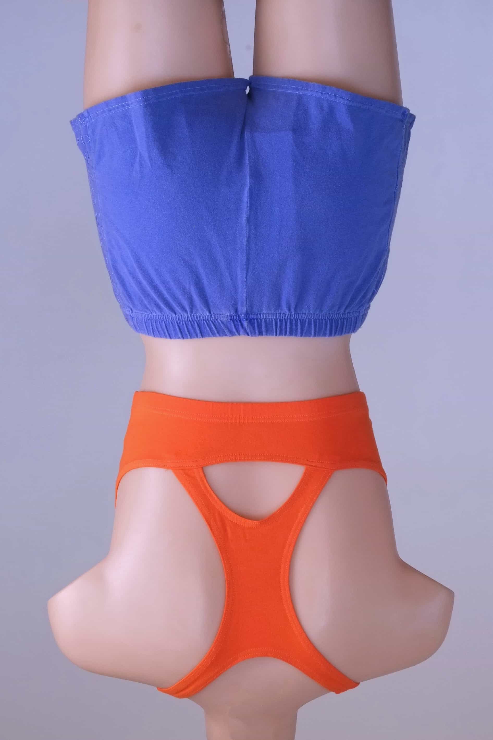 Back view of a mannequin wearing a Vintage 90s Anniel orange racerback sports bra and blue shorts, highlighting the keyhole detail.