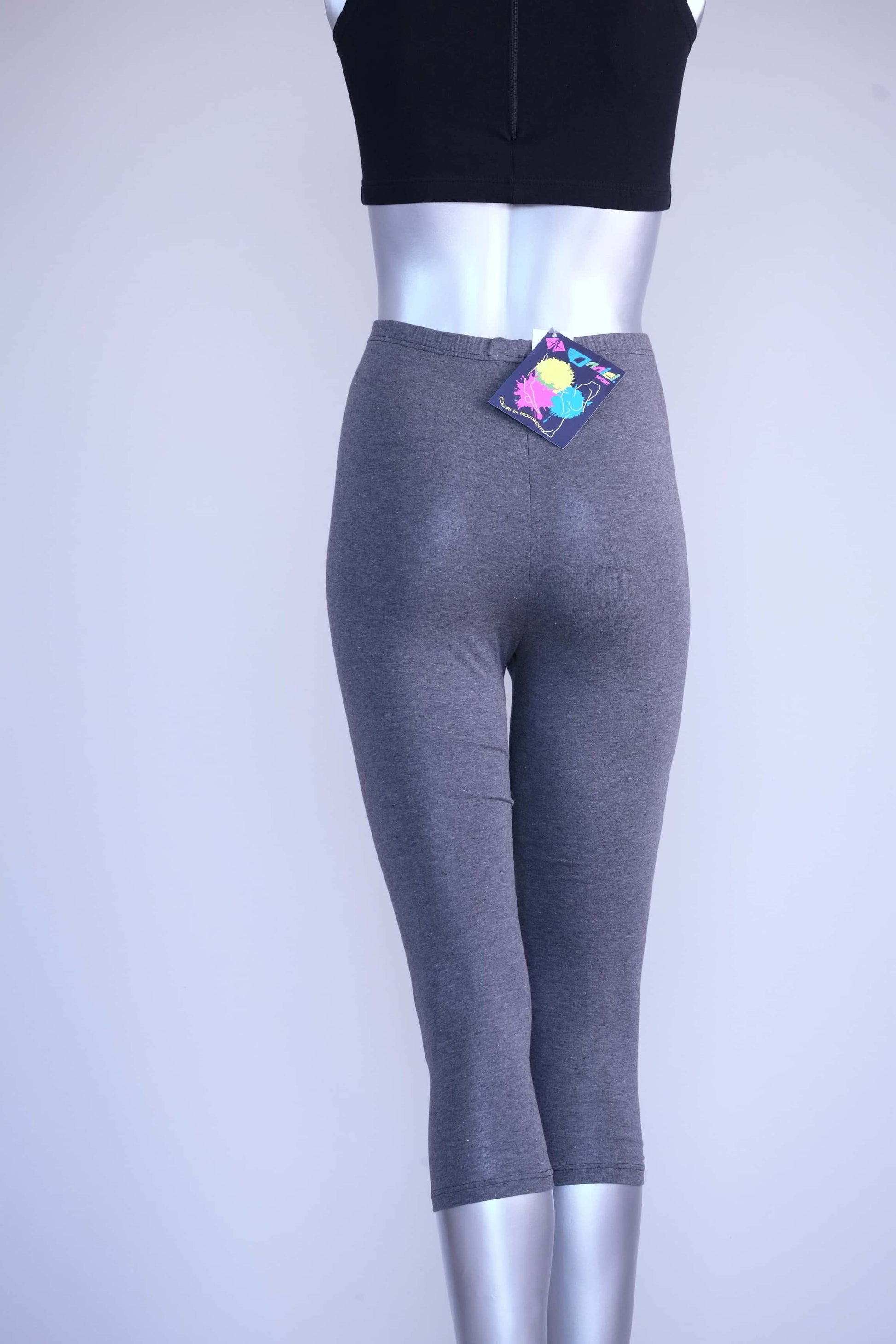 Back view of heather charcoal Anniel vintage capri leggings on a silver mannequin, with the original tag attached.