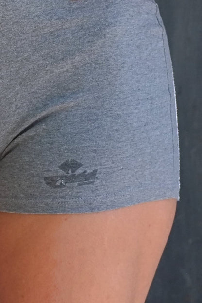 Detailed shot of faded Anniel Sport logo on grey cotton romper.
