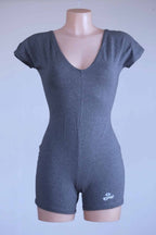 Anniel athletic romper in heather charcoal displayed on mannequin with V-neck and fitted silhouette.